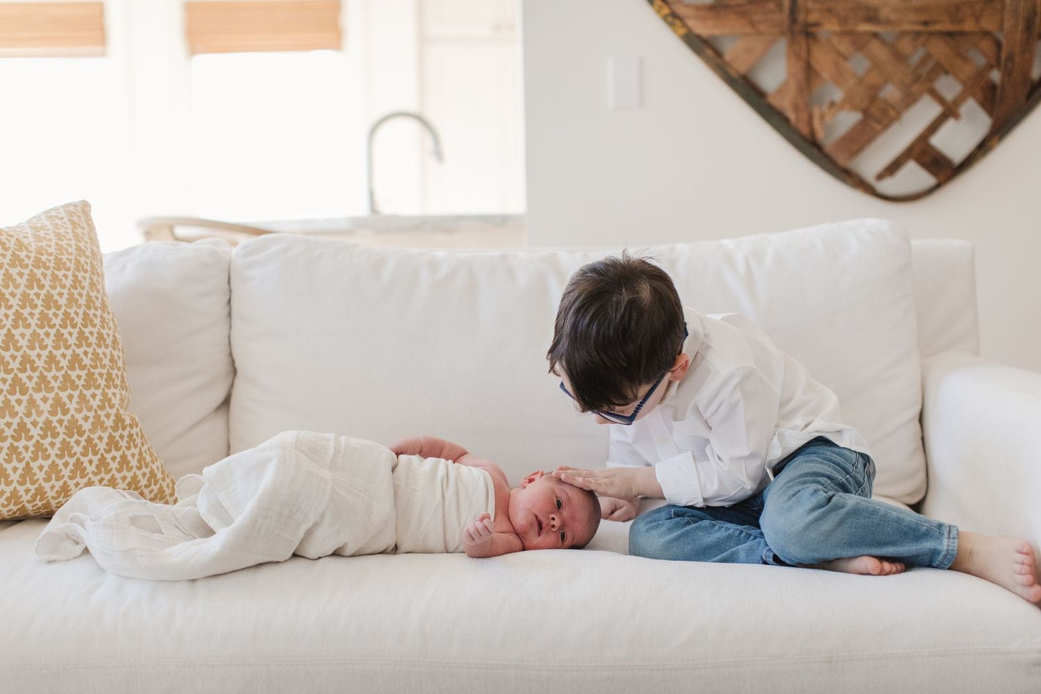 A quiet moment shared on a comfortable white couch with decorative pillows.