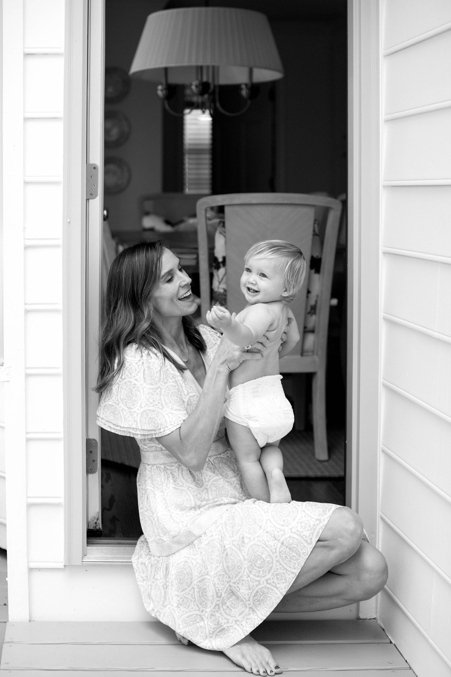 Four sequential photos show a touching doorway scene in black and white.