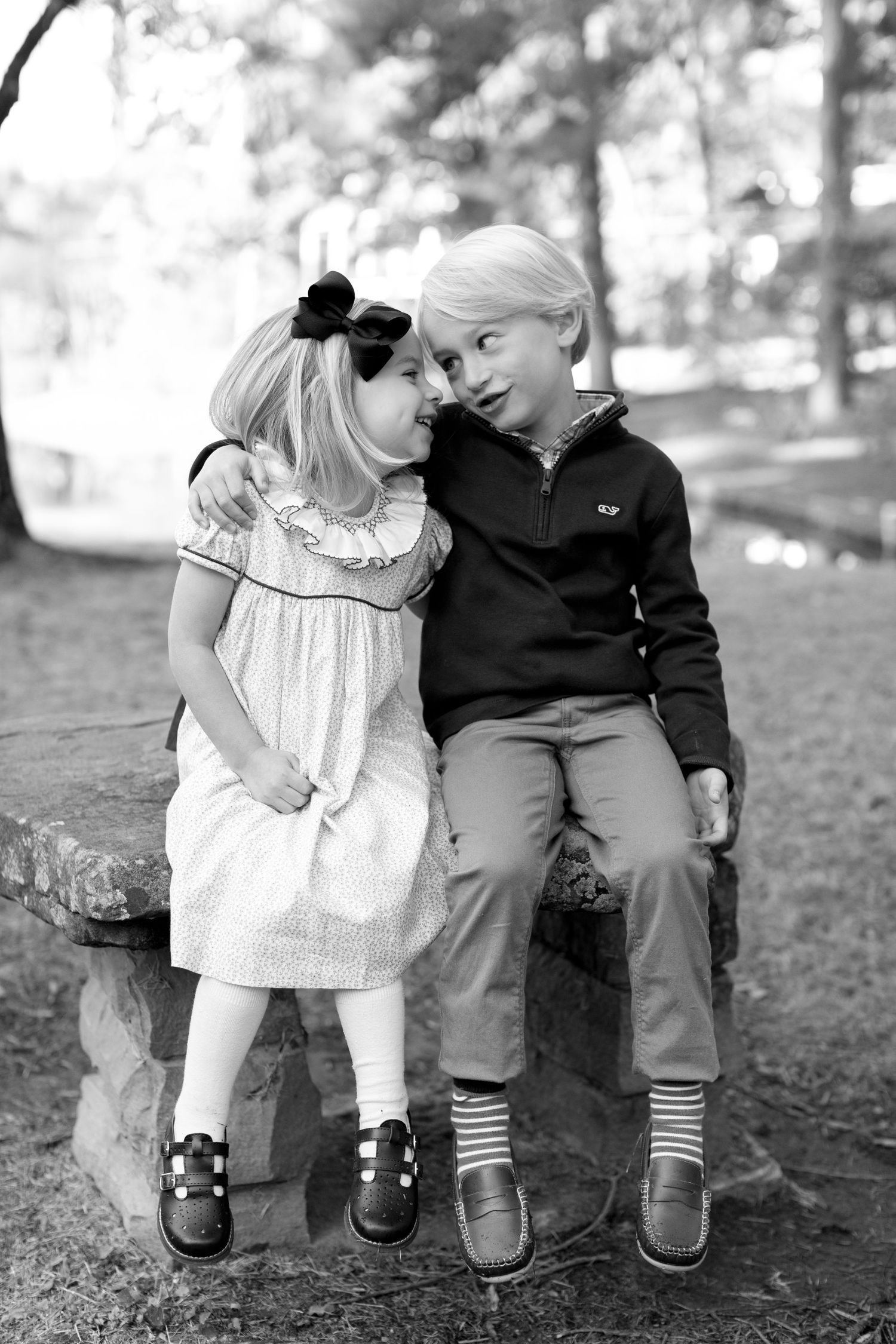 A child in a white dress sits next to an elderly person on a bench in a park setting, shown in multiple black and white photos.