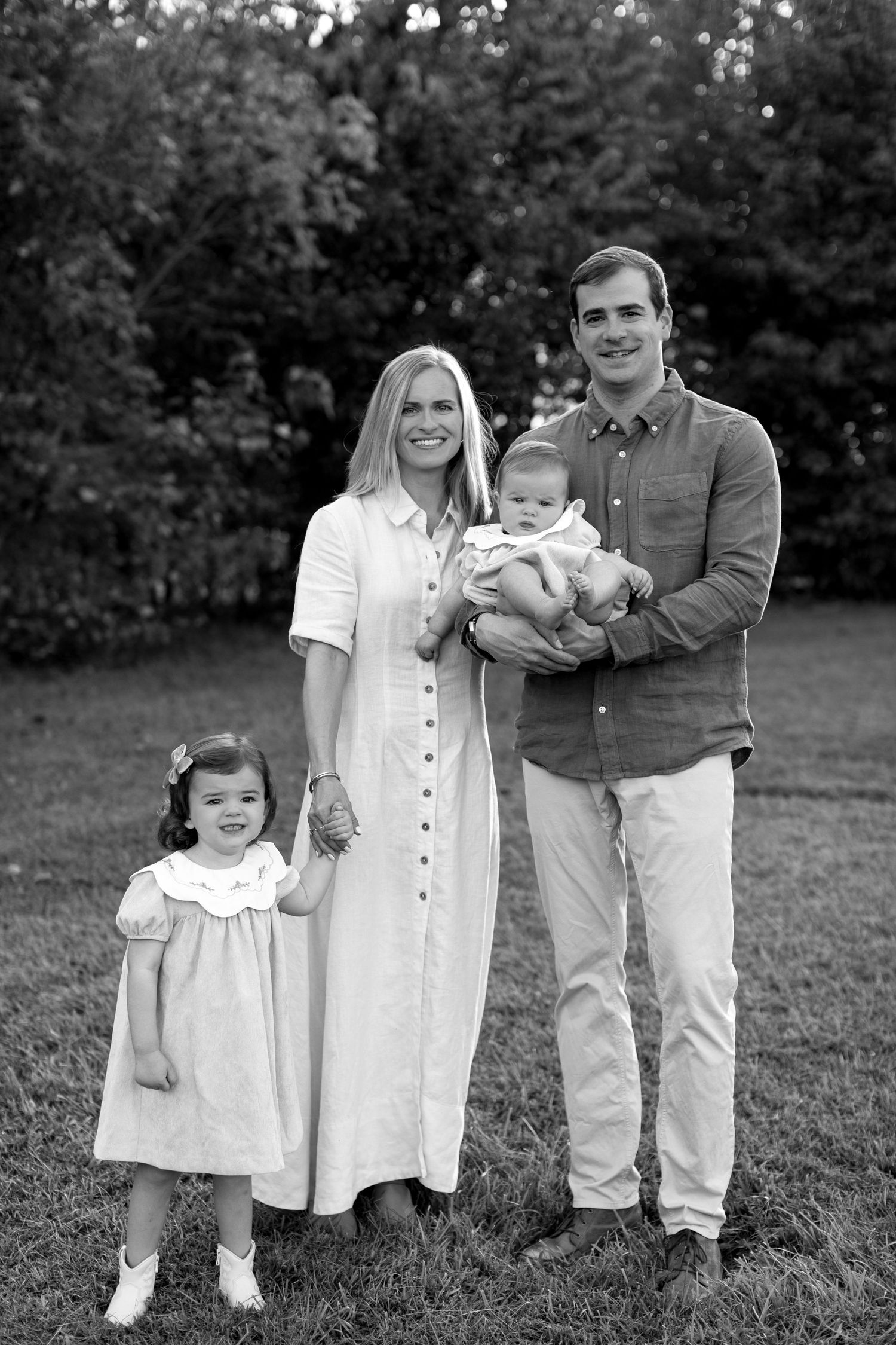 A black and white photo sequence showing a family in casual attire posing together outdoors on grass.