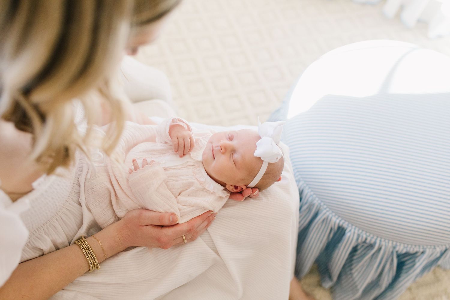 A series of tender newborn photography images showing tiny hands, feet, and delicate poses on soft white fabric.