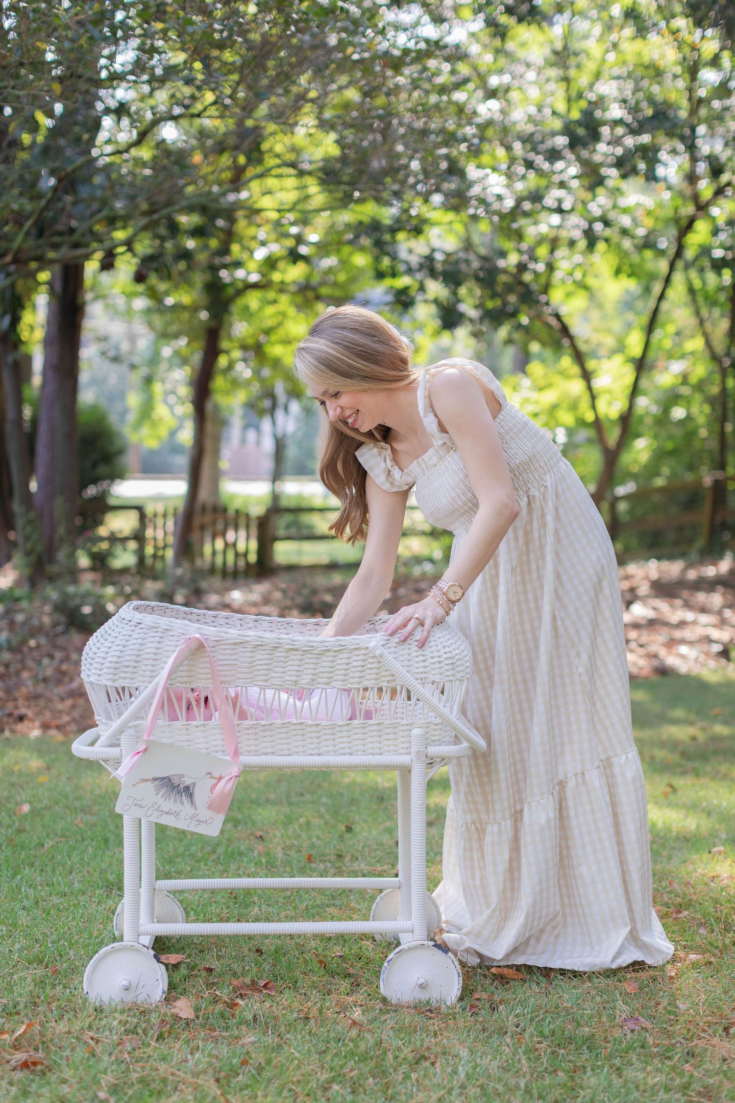 A tender outdoor scene showing a rustic white bench with a person in a flowing white dress sitting beside it.