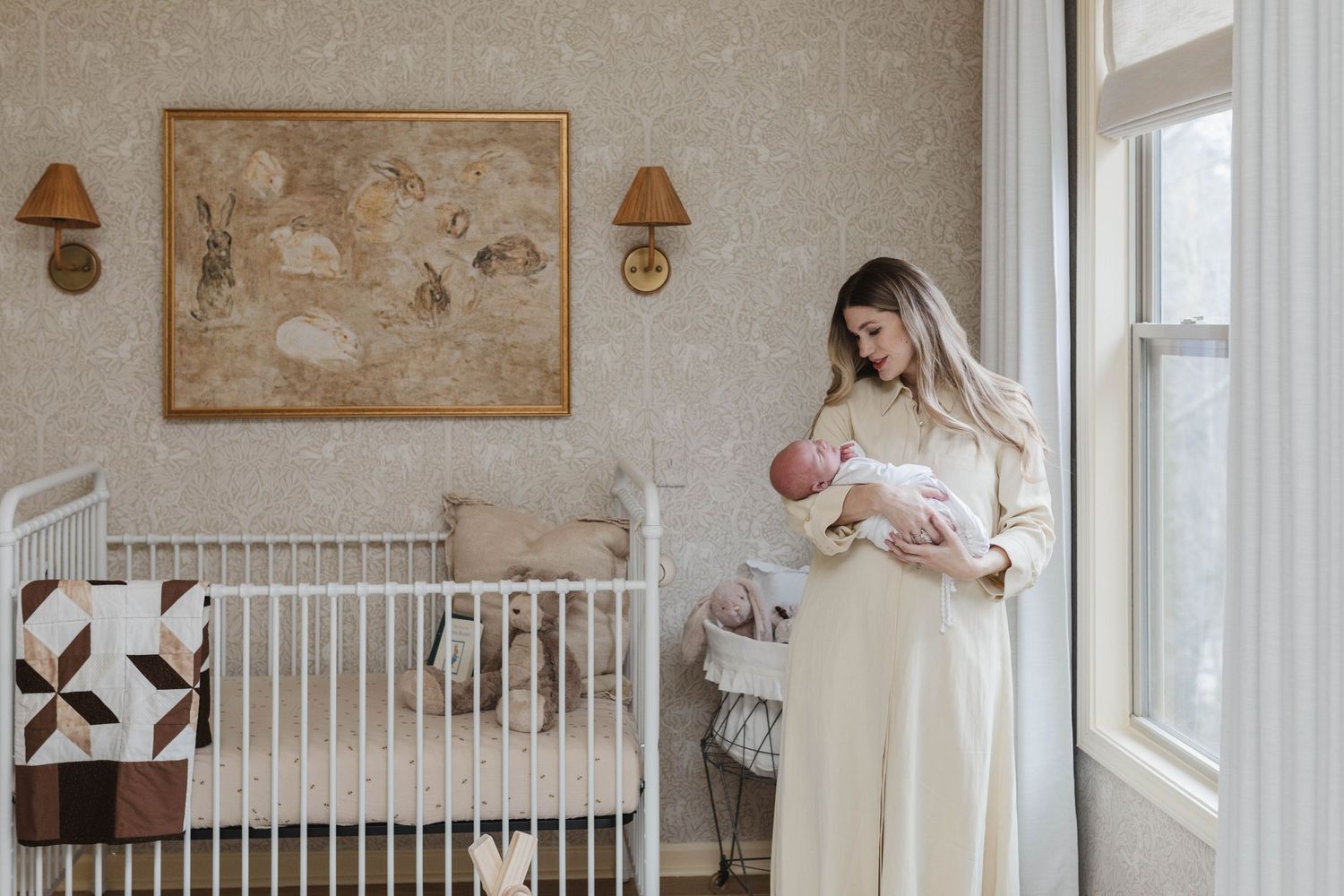 A serene nursery scene with a white crib, wall art, and warm lighting.