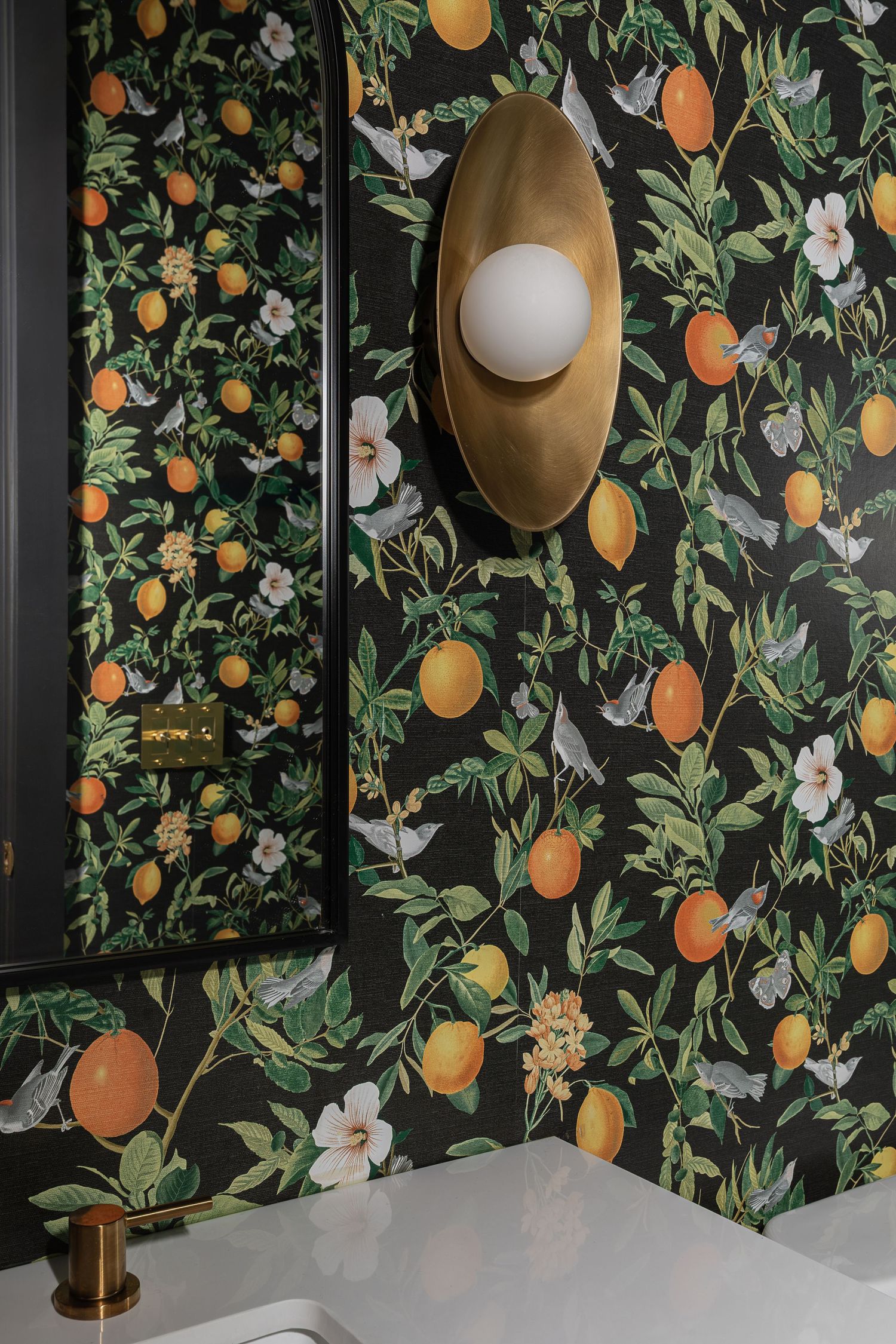 Bold citrus fruit wallpaper with oranges and lemons creates a dramatic accent wall. Atlanta Interior Design Photography