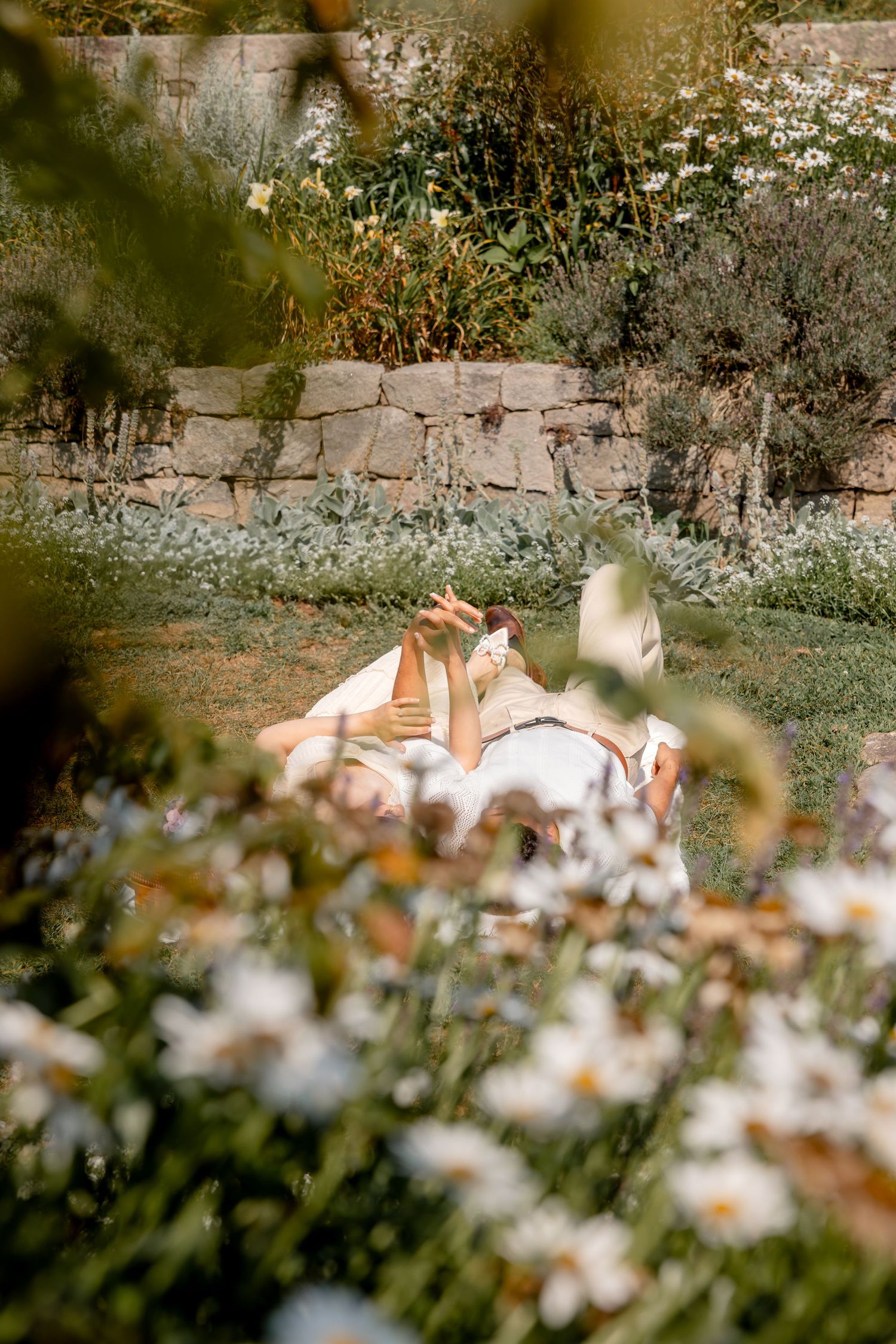 Artistic wedding photo through wildflowers and garden foliage.