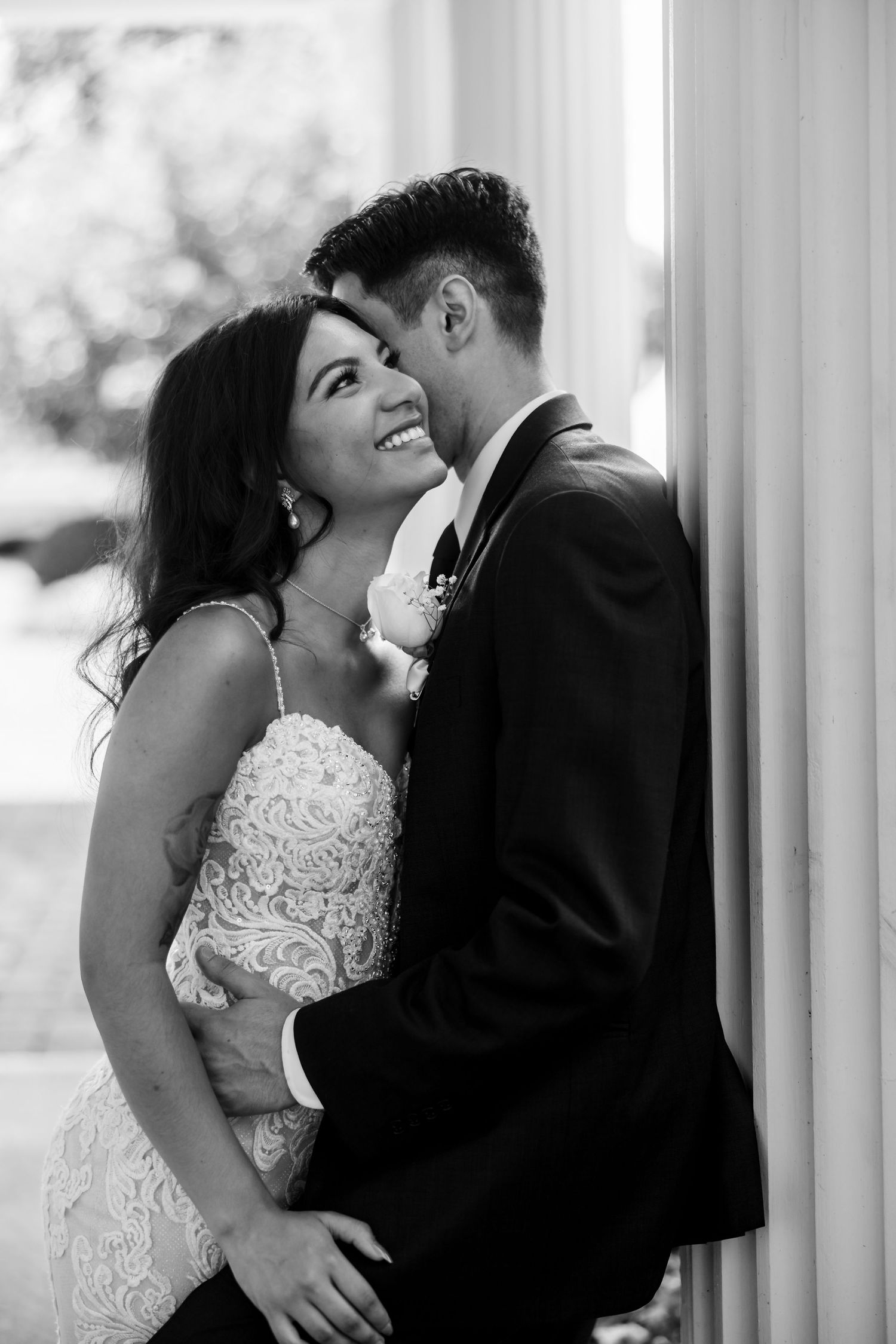 Black and white wedding photos showing intimate moments between newlyweds.