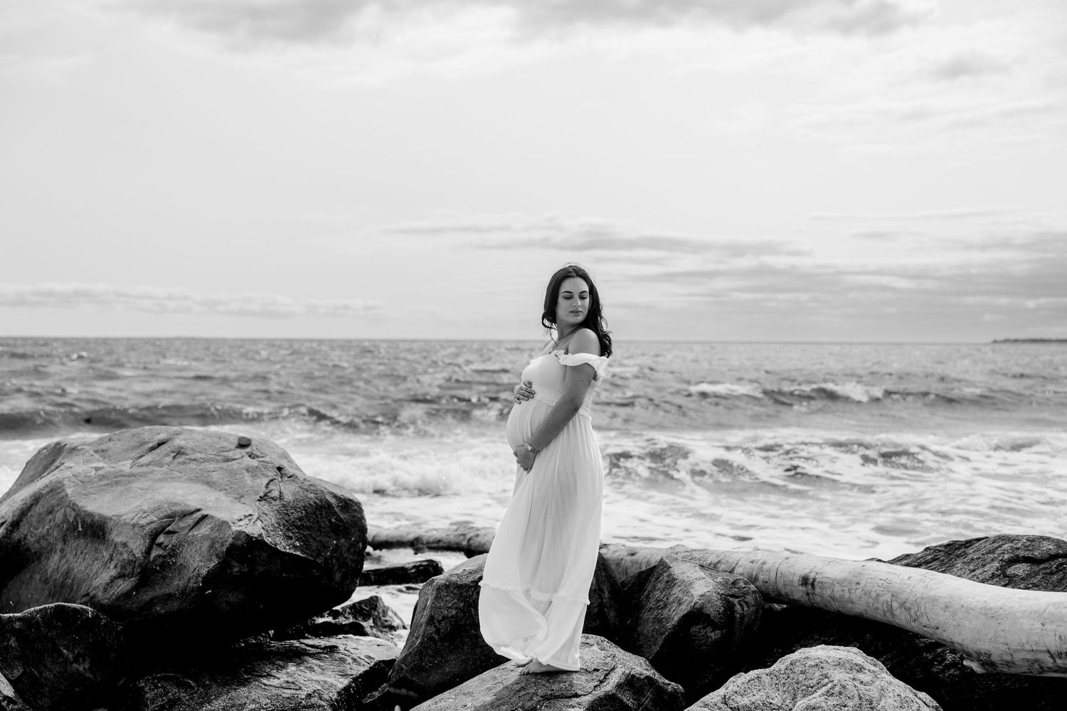 A scenic panorama of a rocky coastline with waves crashing against the shore.