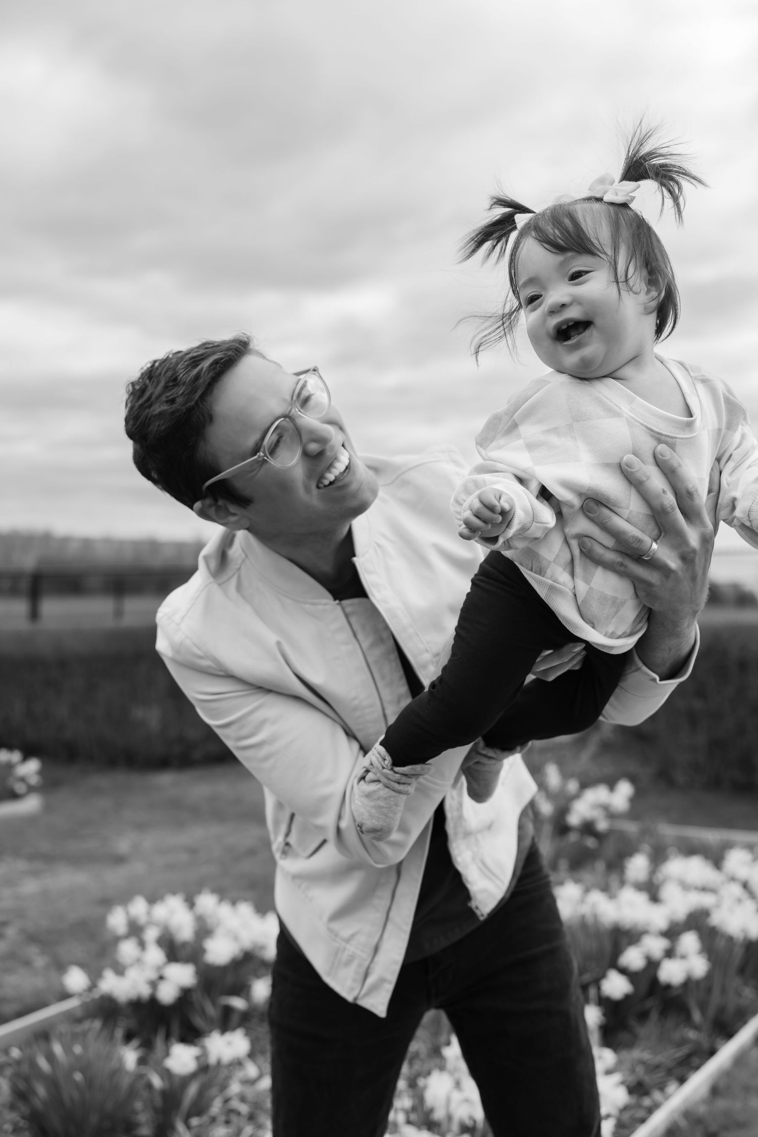 Black and white candid photos showing joyful laughter in a garden setting.