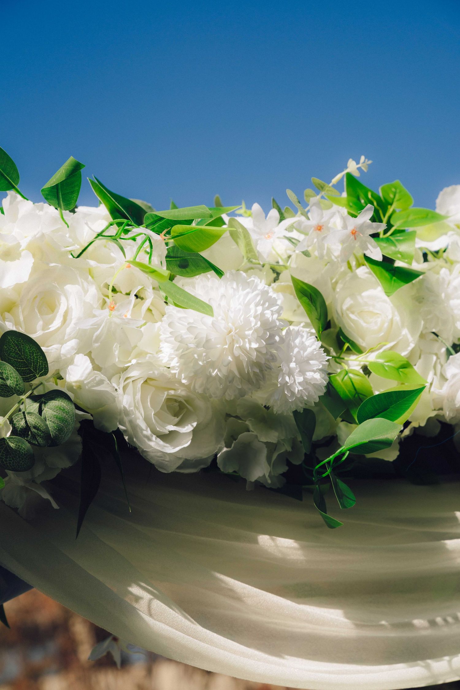 White flowers with a blue sky in the background and edited to look dreamy