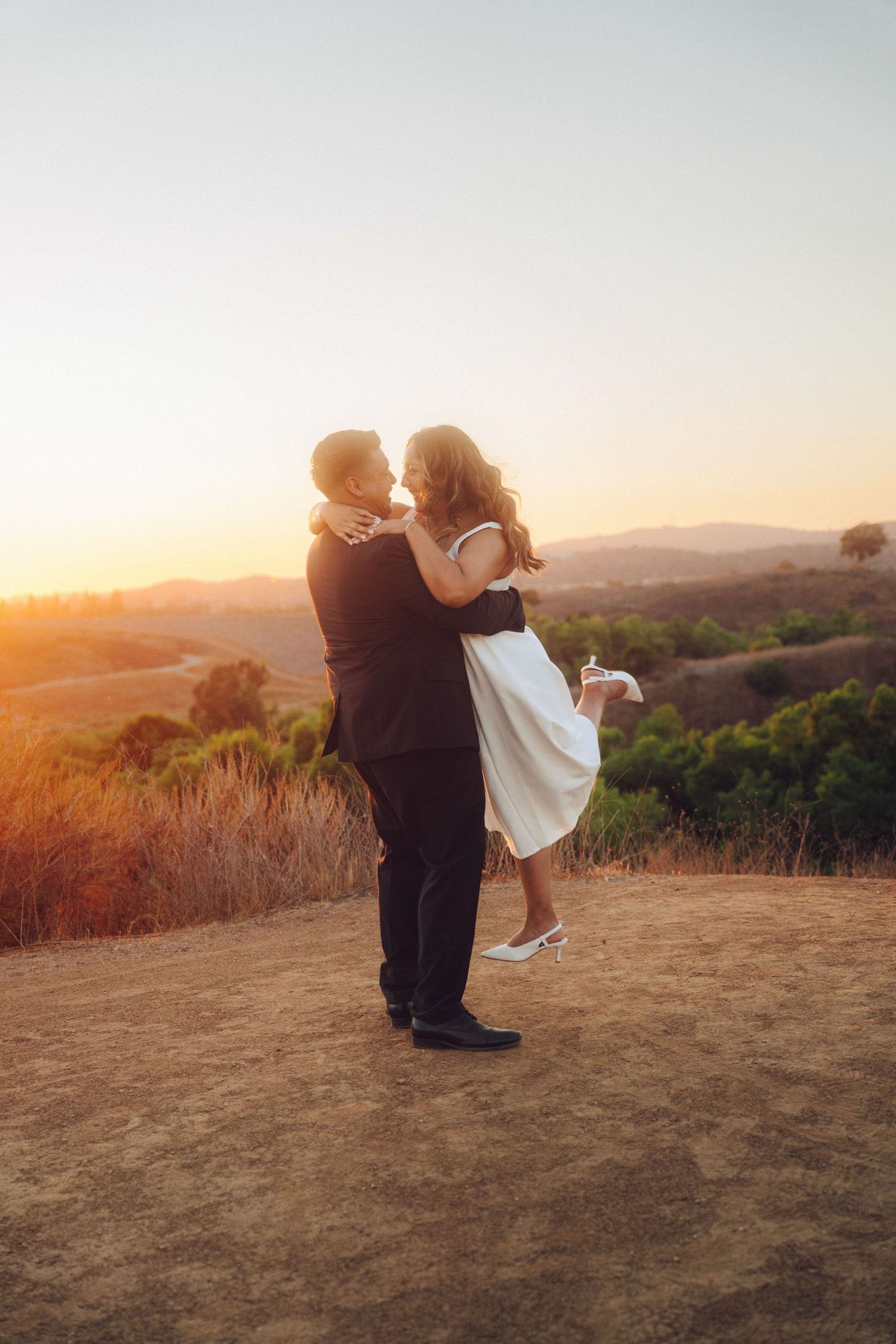 Candid moment of couple enjoying engagement photos in Orange County