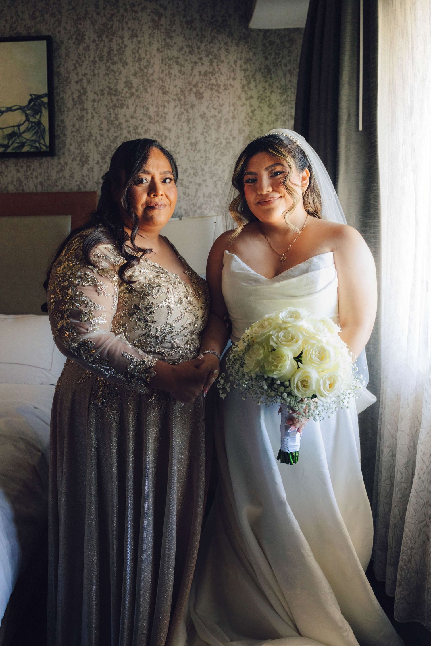 Bride and her mother taking a photo in the room of the double tree located in rosemead