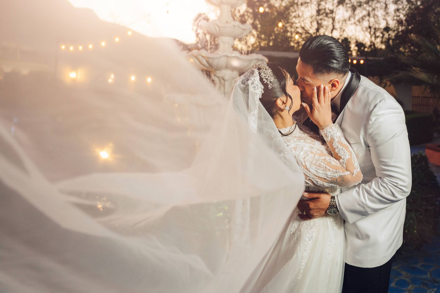 Bride and Groom hero shot with her veil extended out to fill in the frame