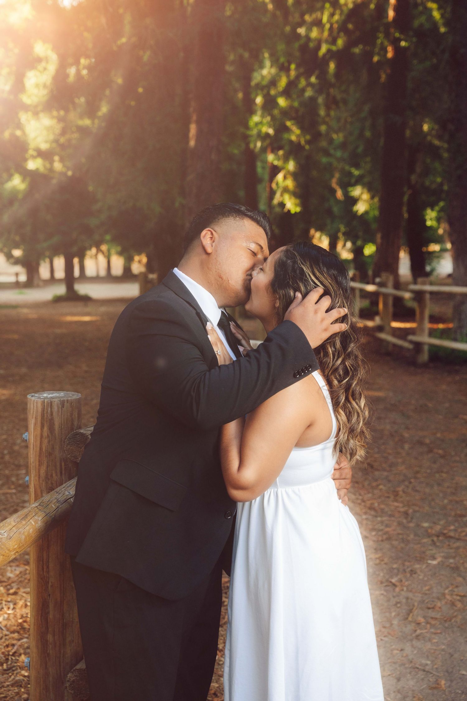 Engaged couple sharing a kiss outdoors at Yorba Linda