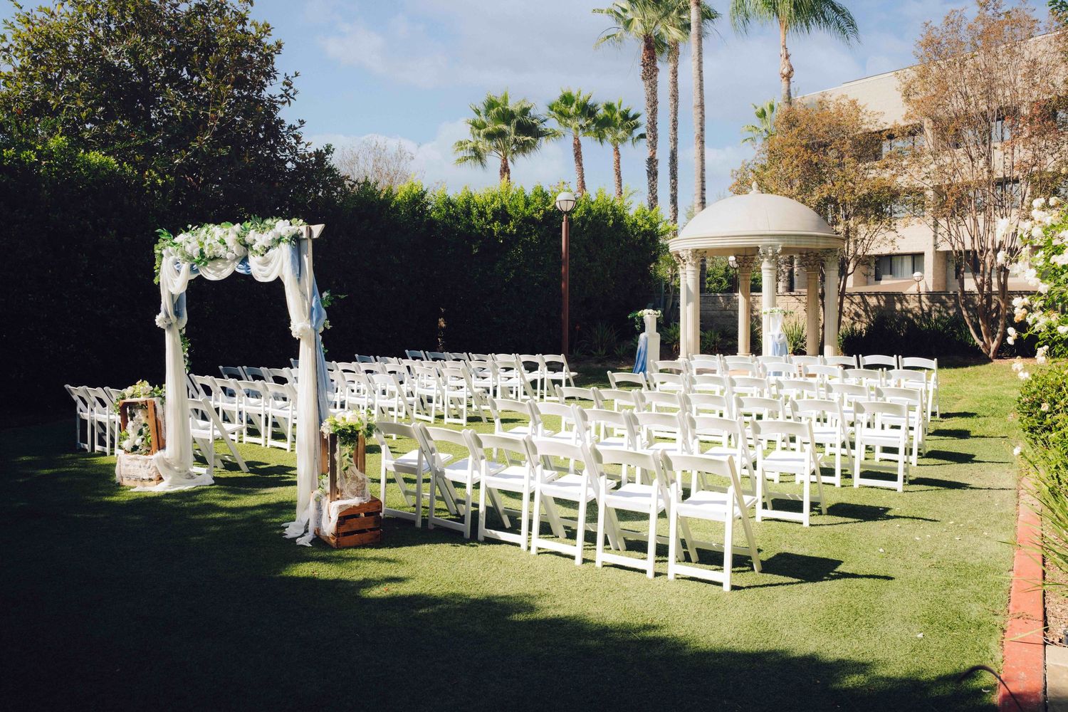 Wide shot of the ceremony area located at the double tree by Hilton located in rosemead. Will all white tables and the gazebo in the photo