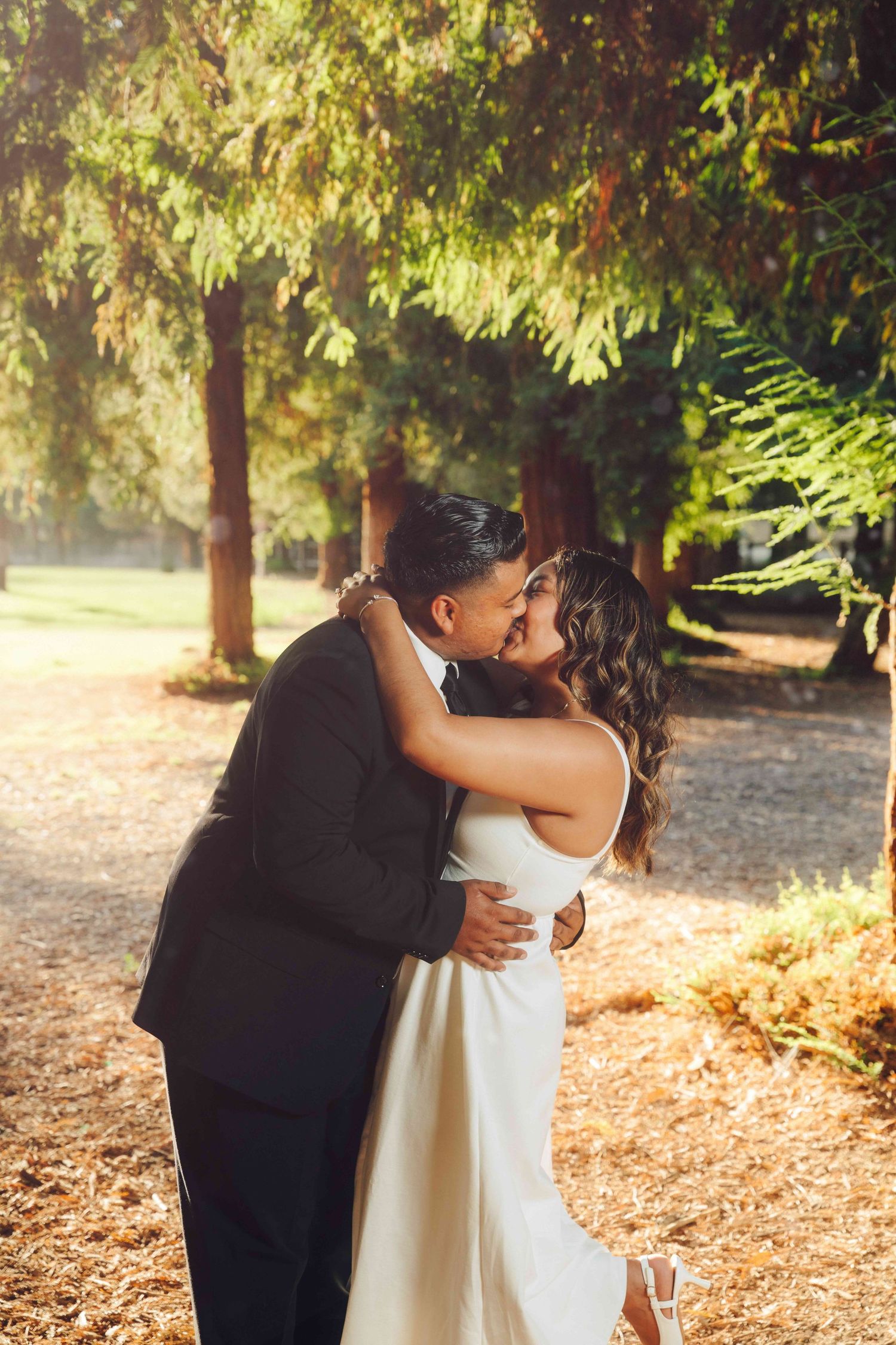 Romantic embrace between engaged couple at Red Wood Grove