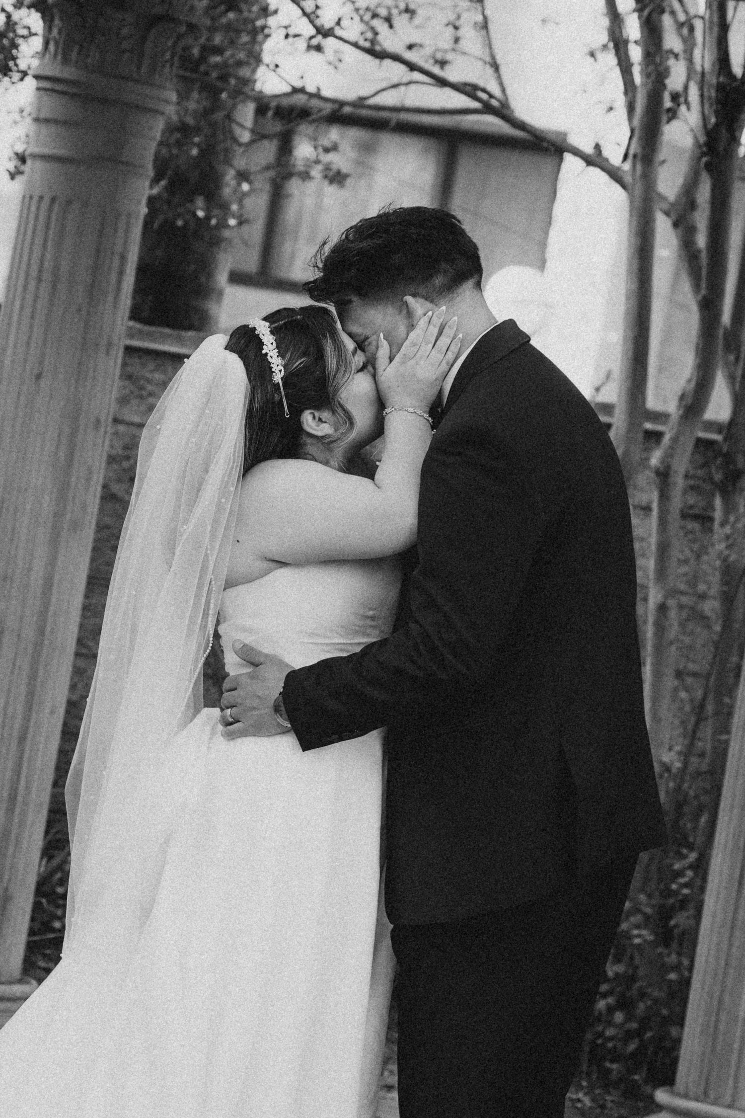 bride and groom kissing under double tree gazebo rosemead