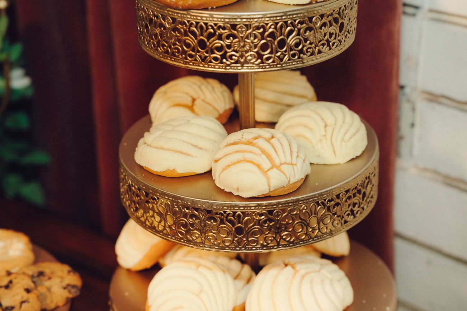 White conchas on gold tier tower for party