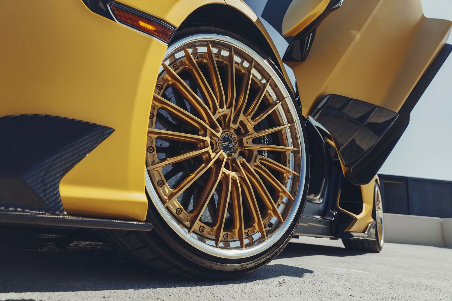 lamborghini revuelto custom mvforged wheels matching the yellow gold color of the car with the door up