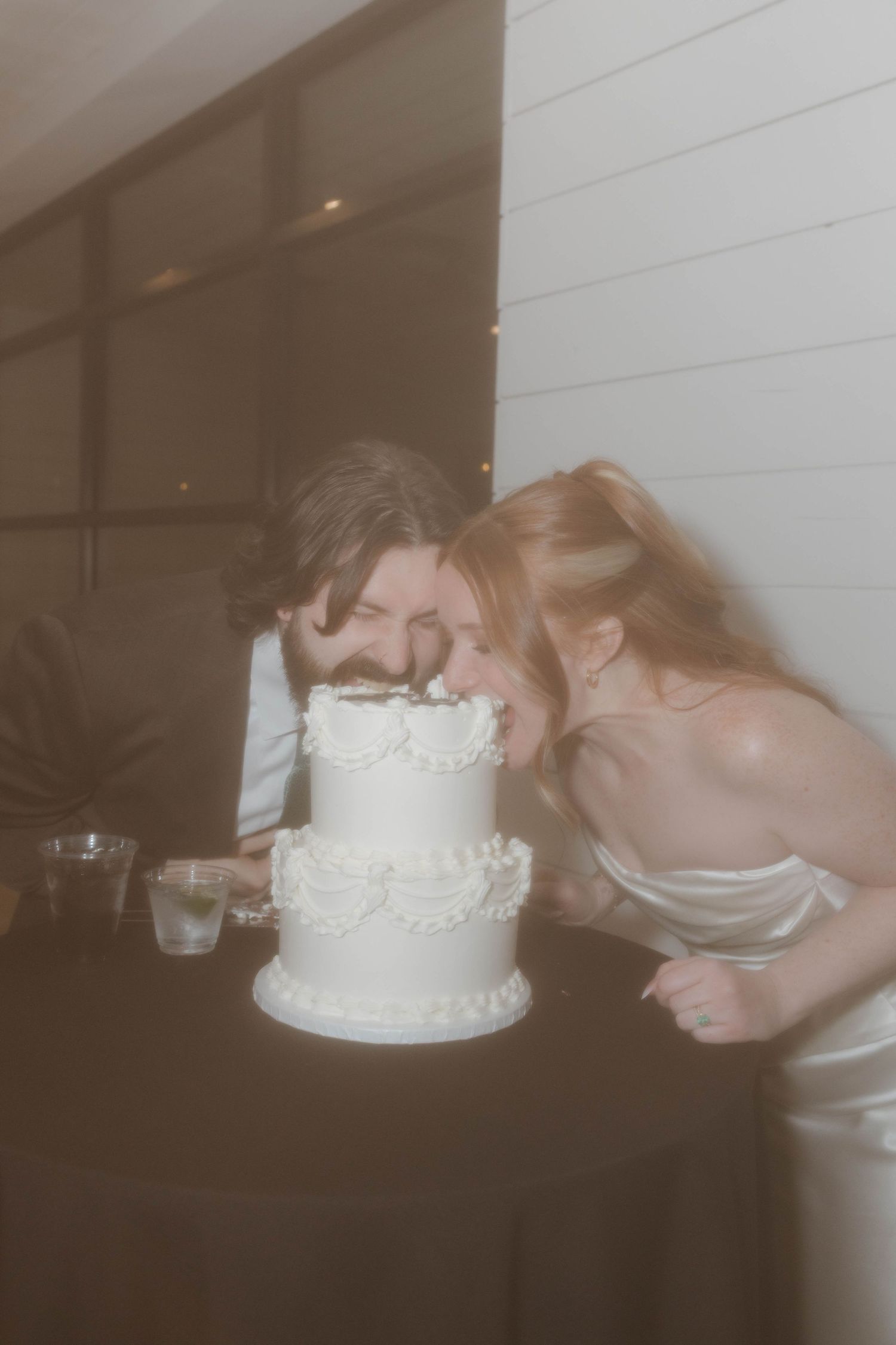 Sequence of wedding cake cutting photos showing couple playfully smashing cake into each others faces.