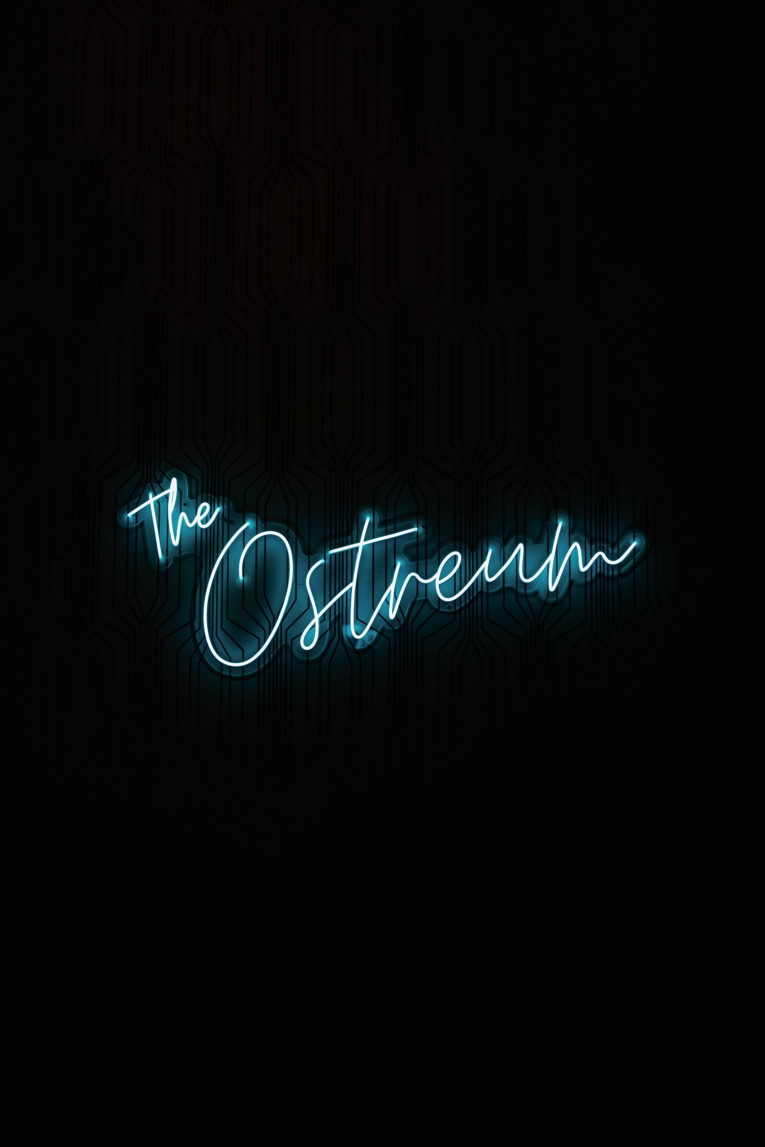 Blue neon sign reading 'The Ostream' glowing against a dark background.