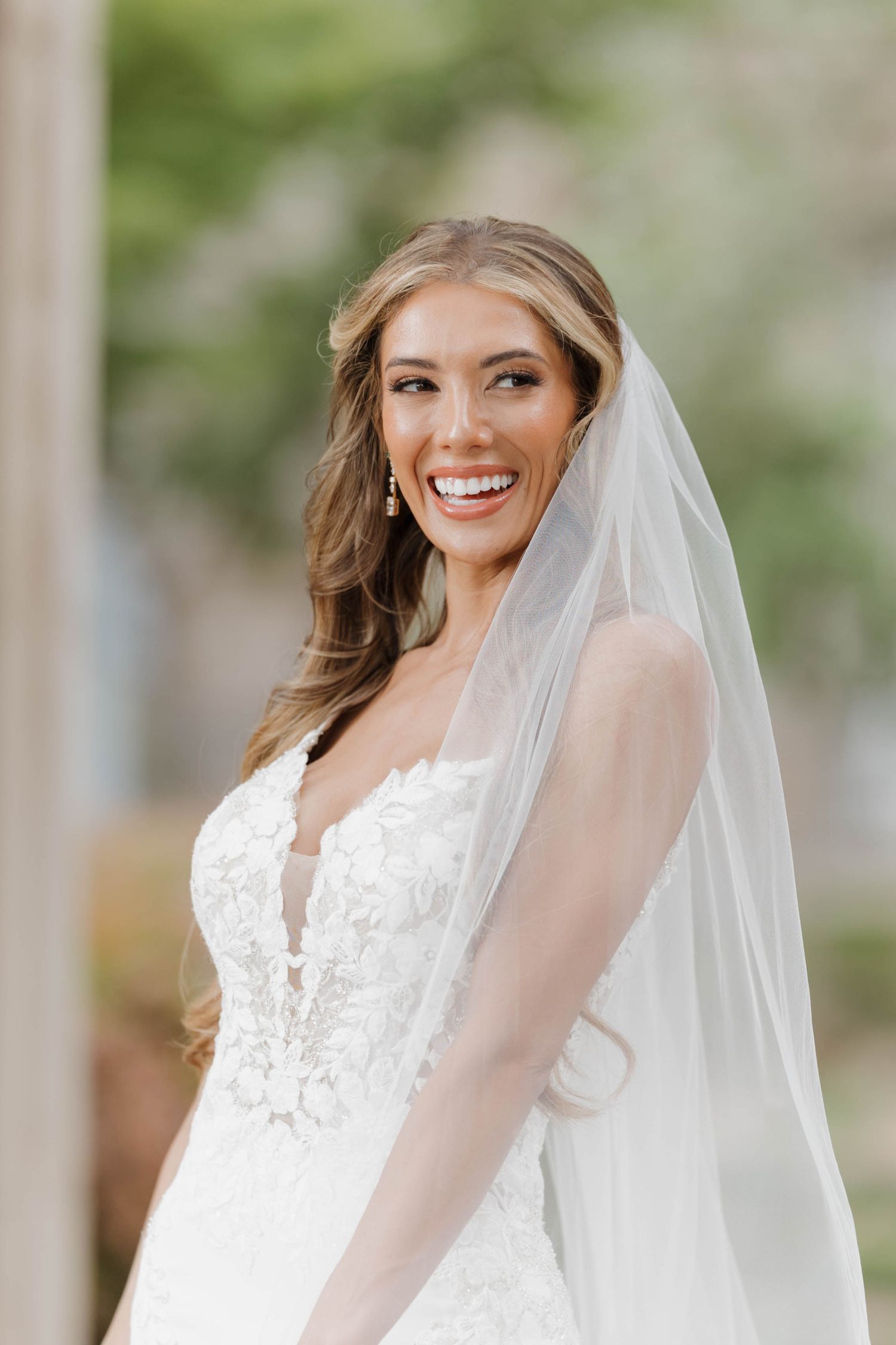 Side-by-side portraits of a radiant bride in a white lace wedding gown with flowing veil against a soft outdoor backdrop.