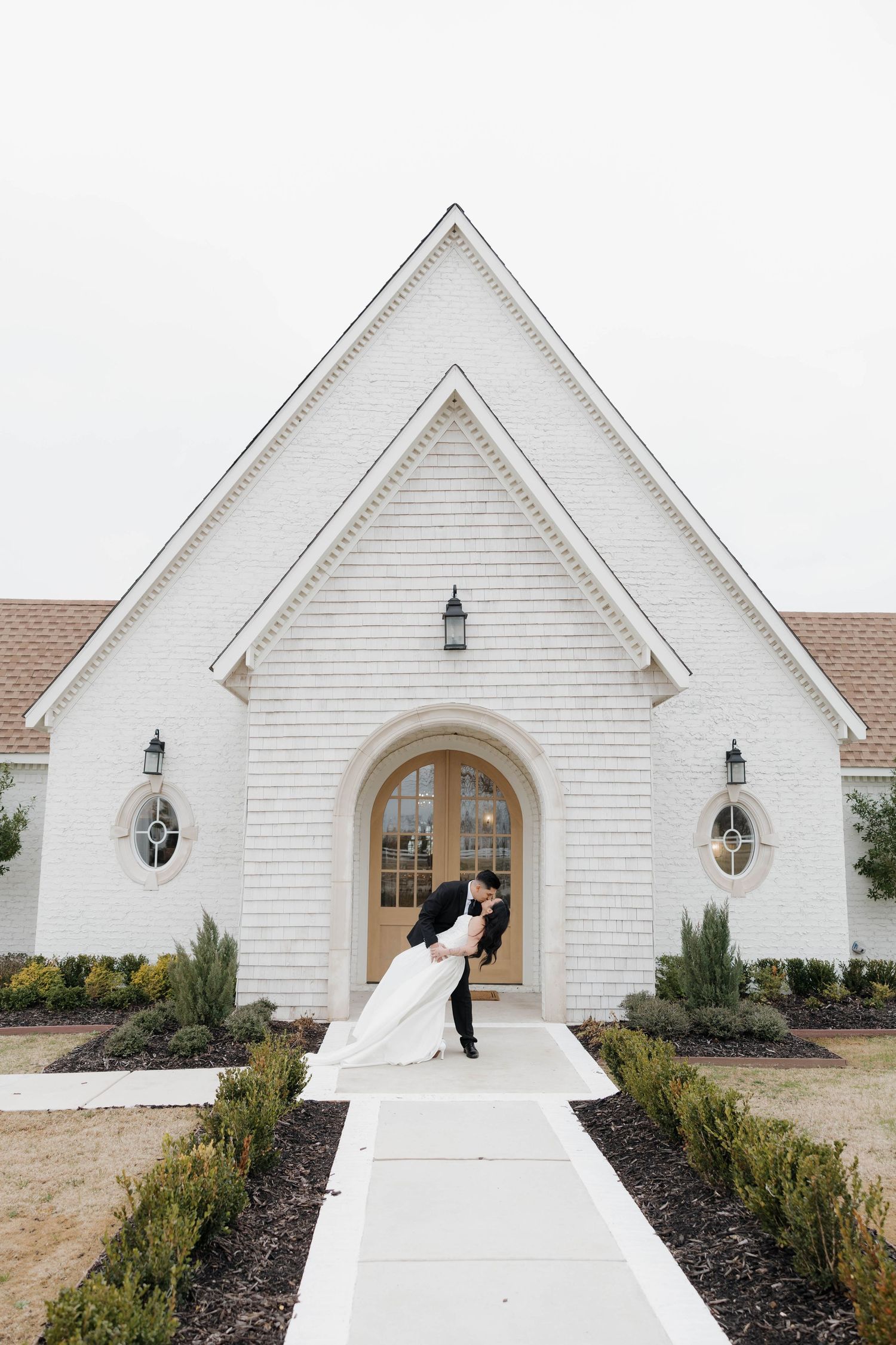 Progressive wedding photos showing a white chapel venue with architectural details and landscaping.
