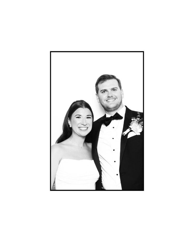 Black and white formal portrait of a bride and groom.