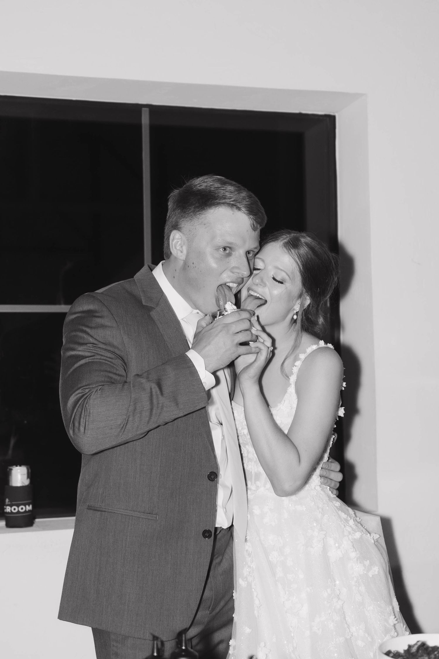 Happy newlyweds share a playful and intimate series of black and white candid moments at their reception.
