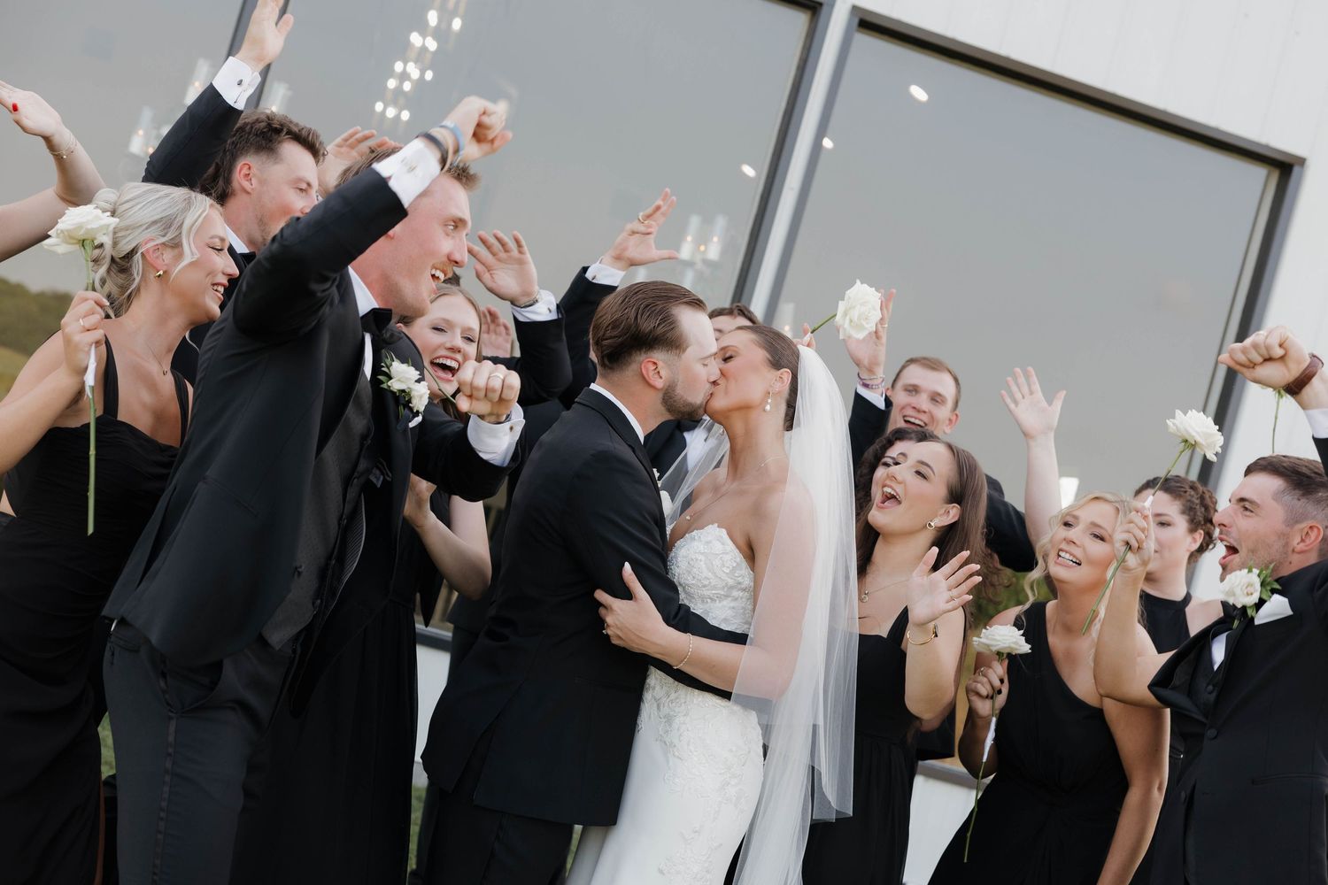 People celebrating at a wedding reception with champagne glasses raised in a toast celebration sequence.