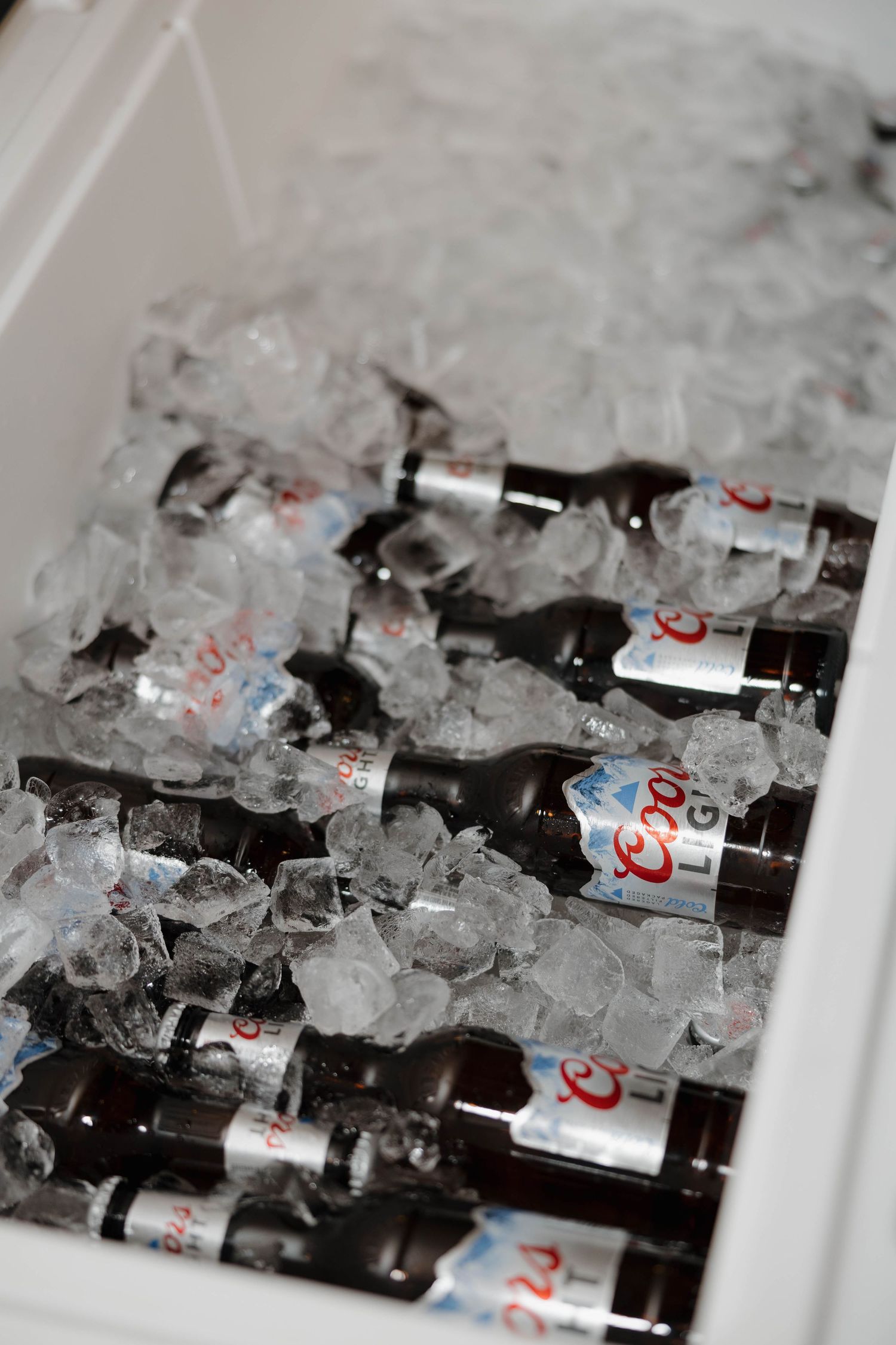 Diet Coke bottles nestled in a bed of ice cubes create a refreshing display of chilled beverages.