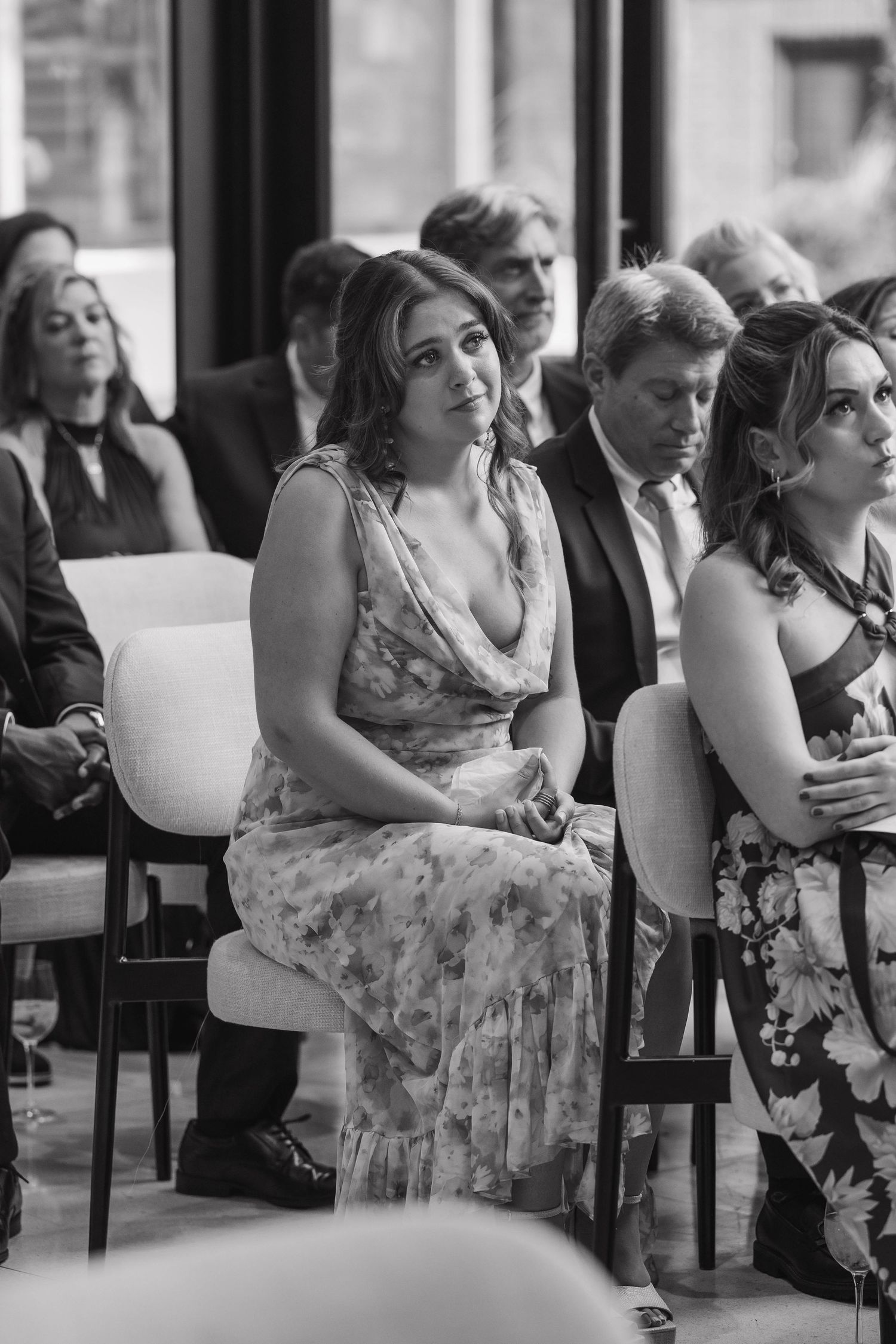 Black and white sequence showing a woman in floral dress reacting emotionally during what appears to be a wedding ceremony.