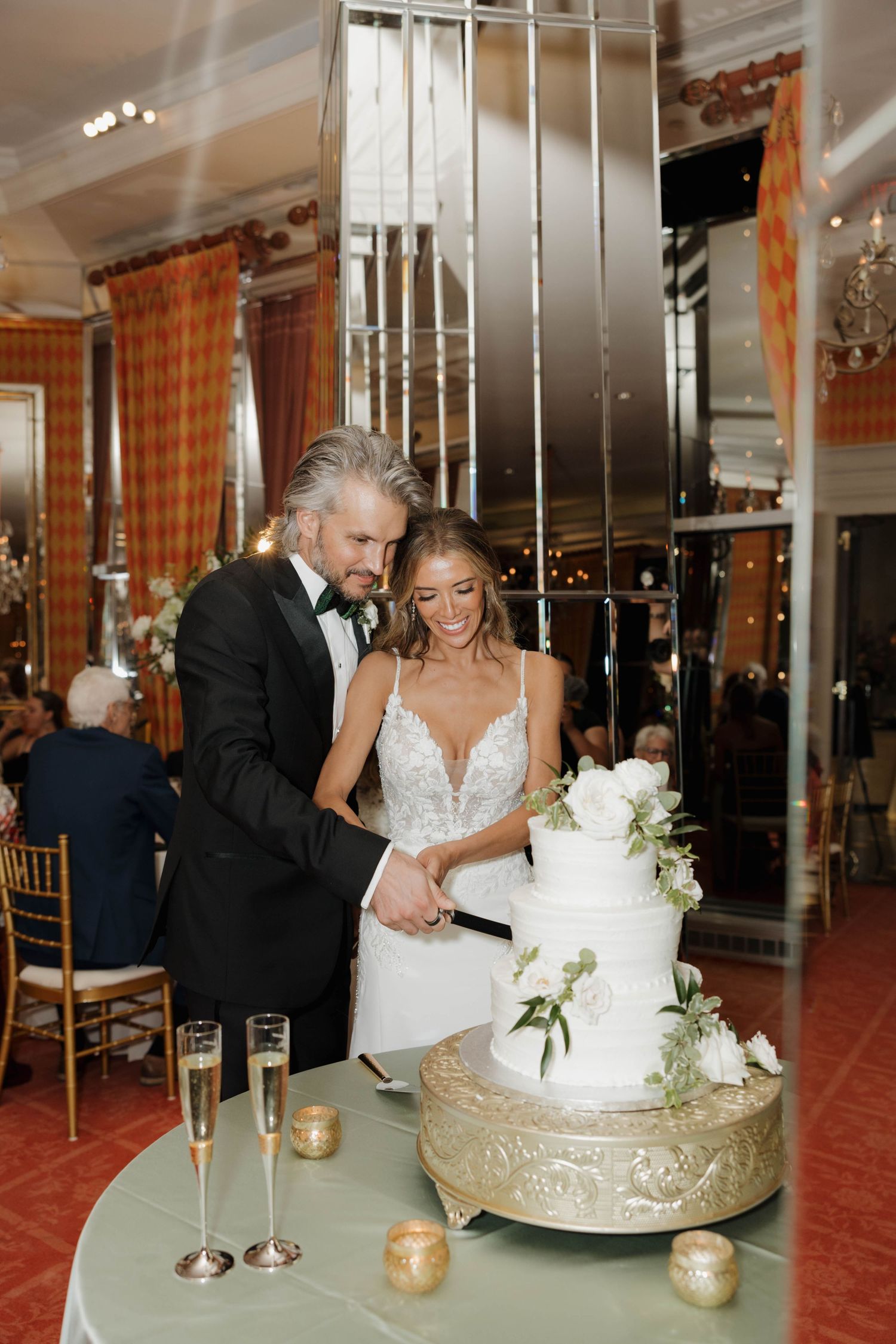 A sequence of elegant wedding cake cutting moments captured in a luxurious venue with golden accents and candlelight.