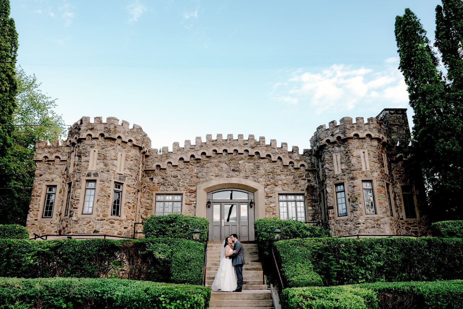 A panoramic collage of stone castle walls and turrets with lush greenery surrounding the historic architecture.