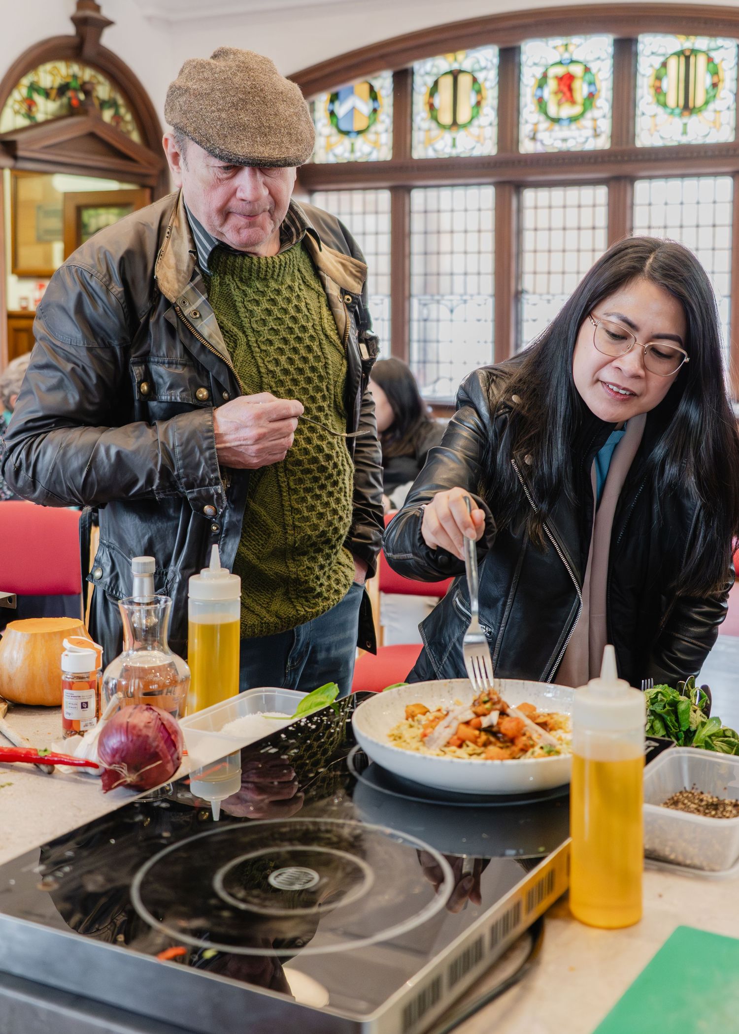 People enjoying a casual meal at a restaurant with drinks and food on the table.