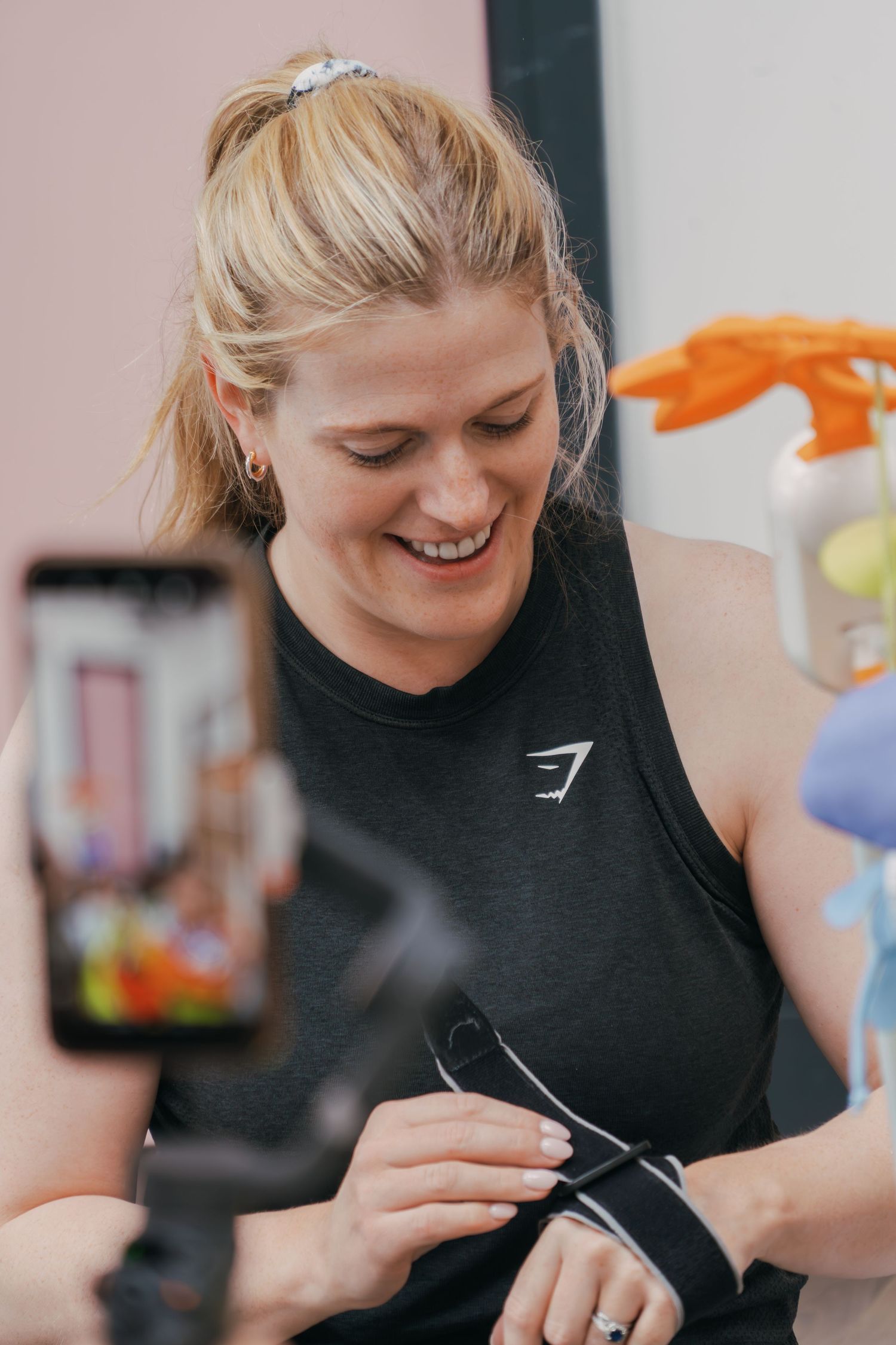 Person in black shirt working intently with focused expression and downward gaze while performing detailed task.
