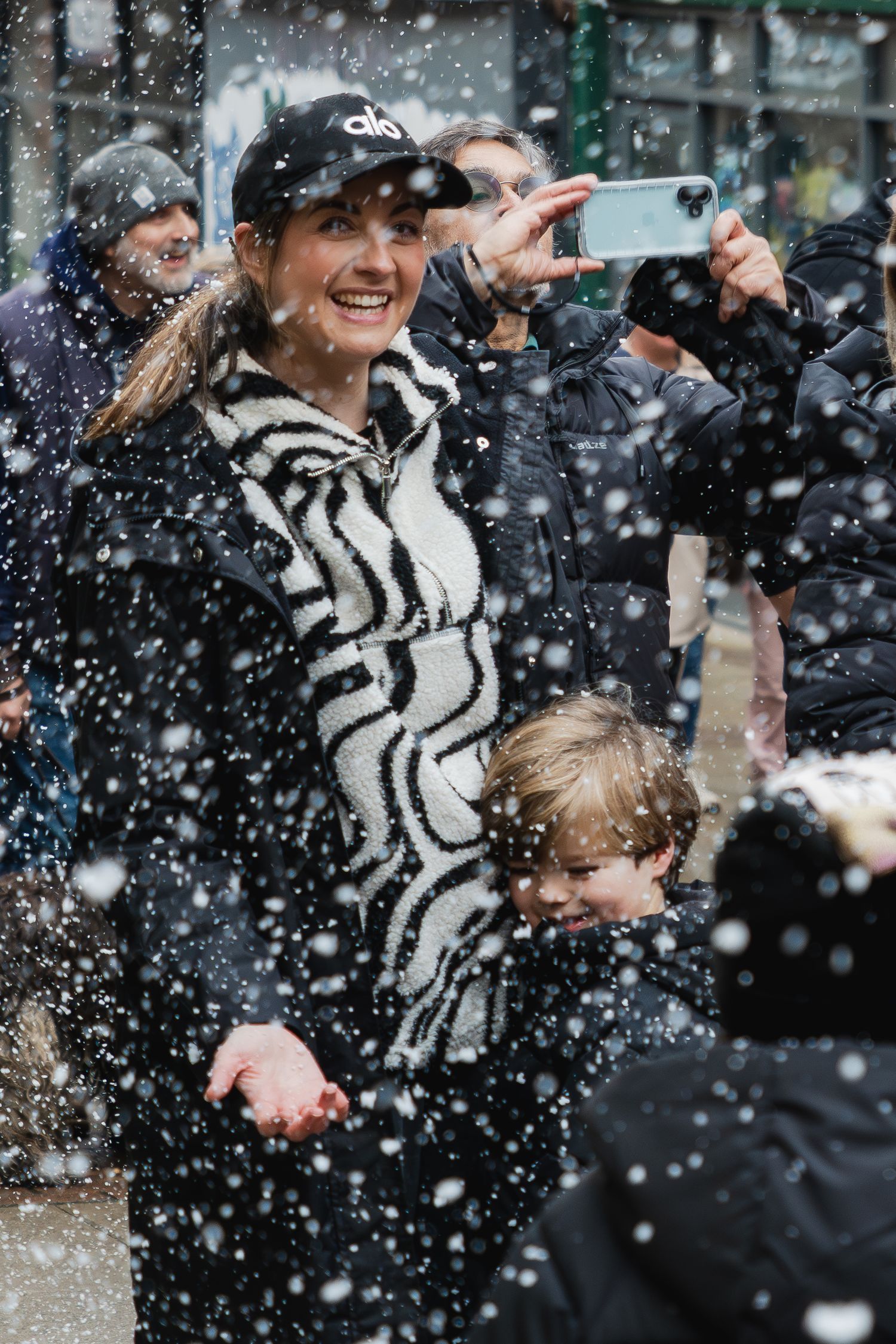 People celebrate in a snowy stadium atmosphere with excitement and joy during a sporting event.
