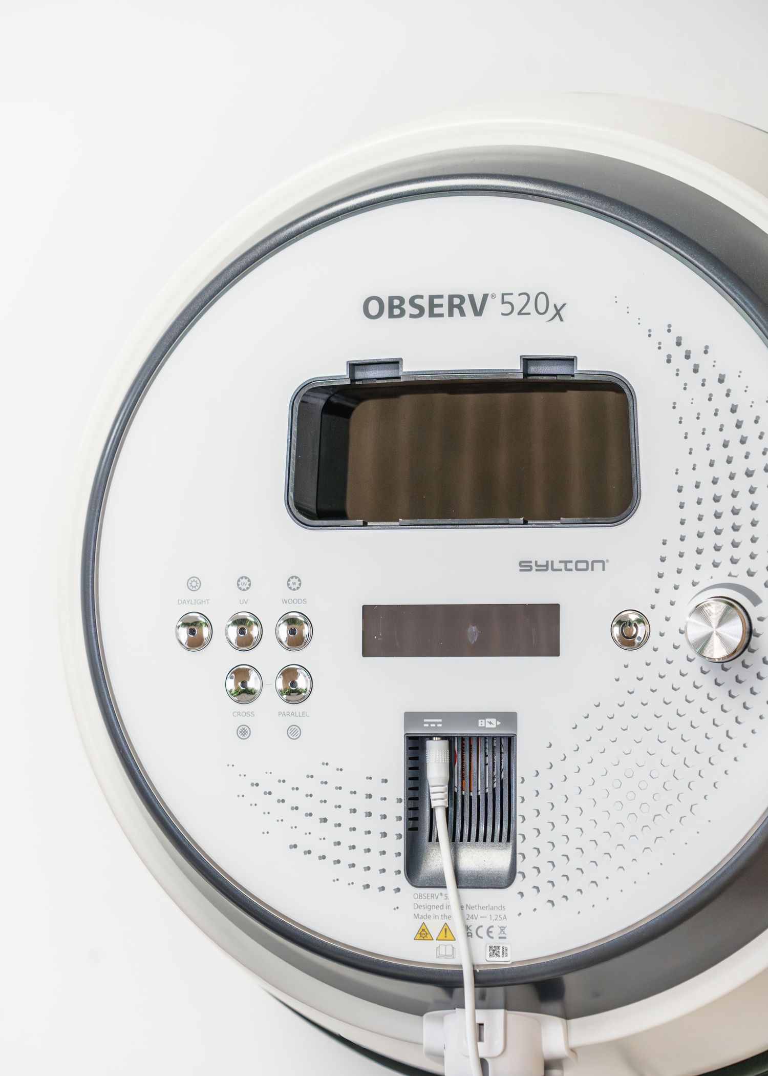 Sylton OBSERV 520x skin analysis device, a white circular facial imaging system with control panel.