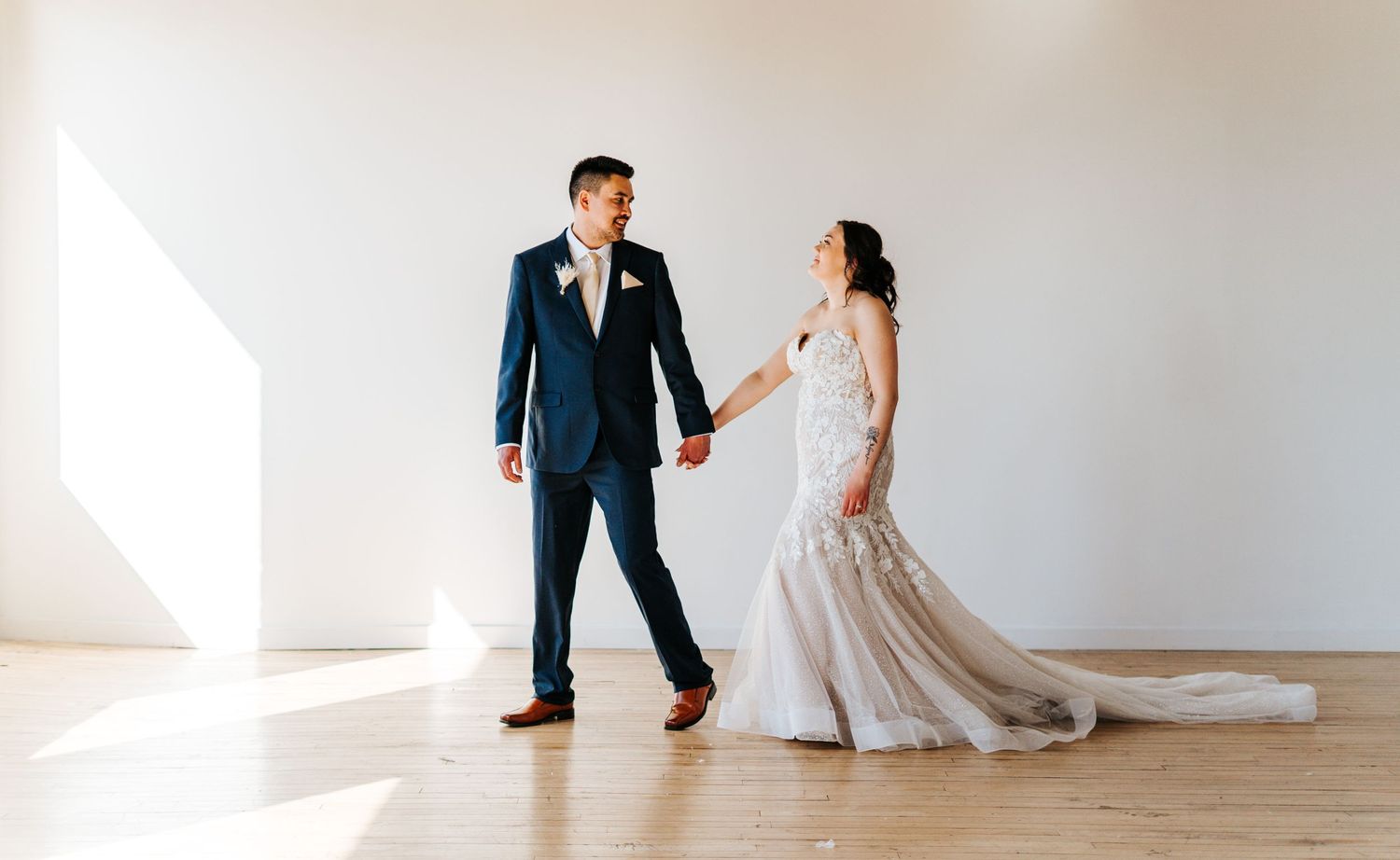 Couple walks across photo studio floor