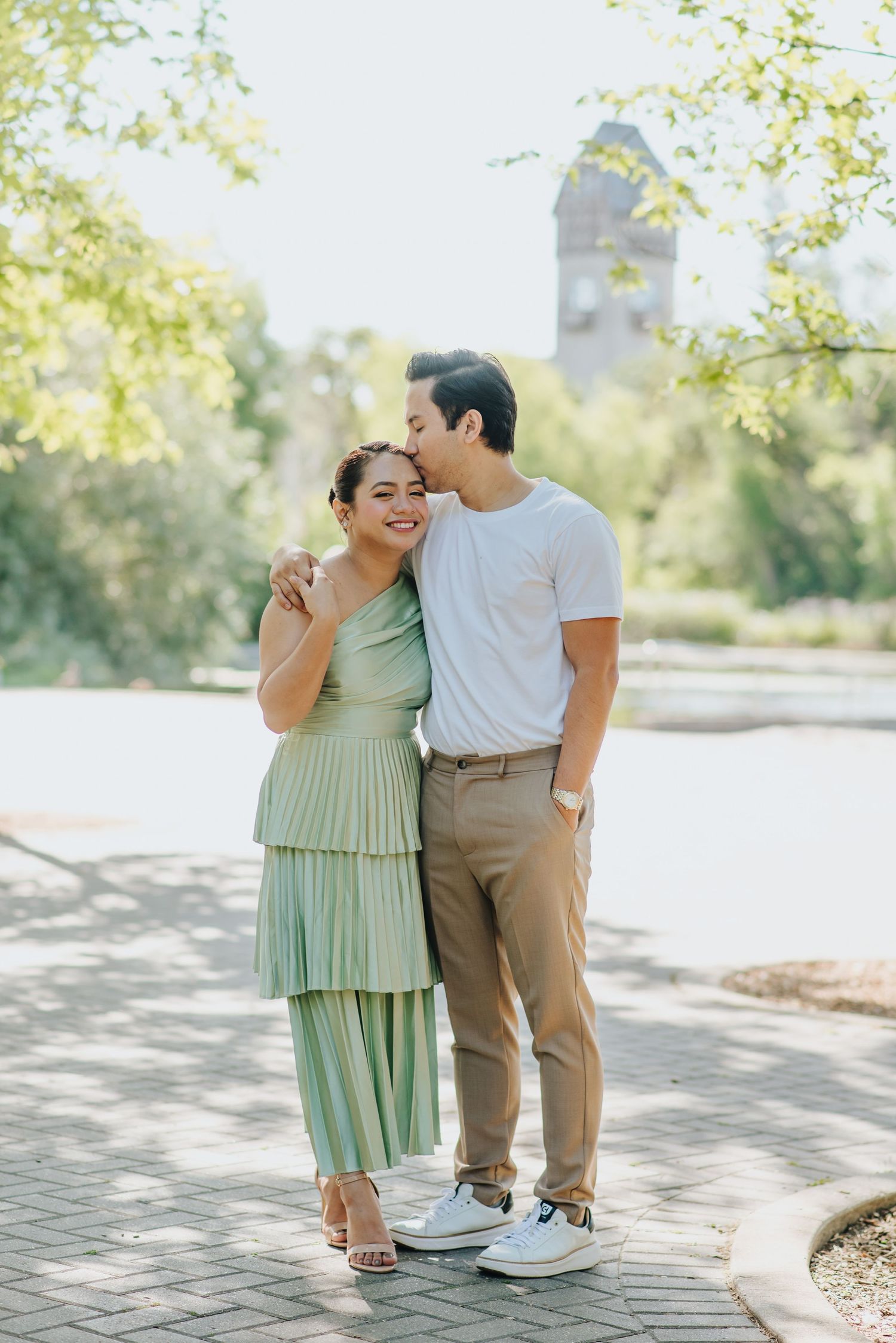 man kisses woman on forhead