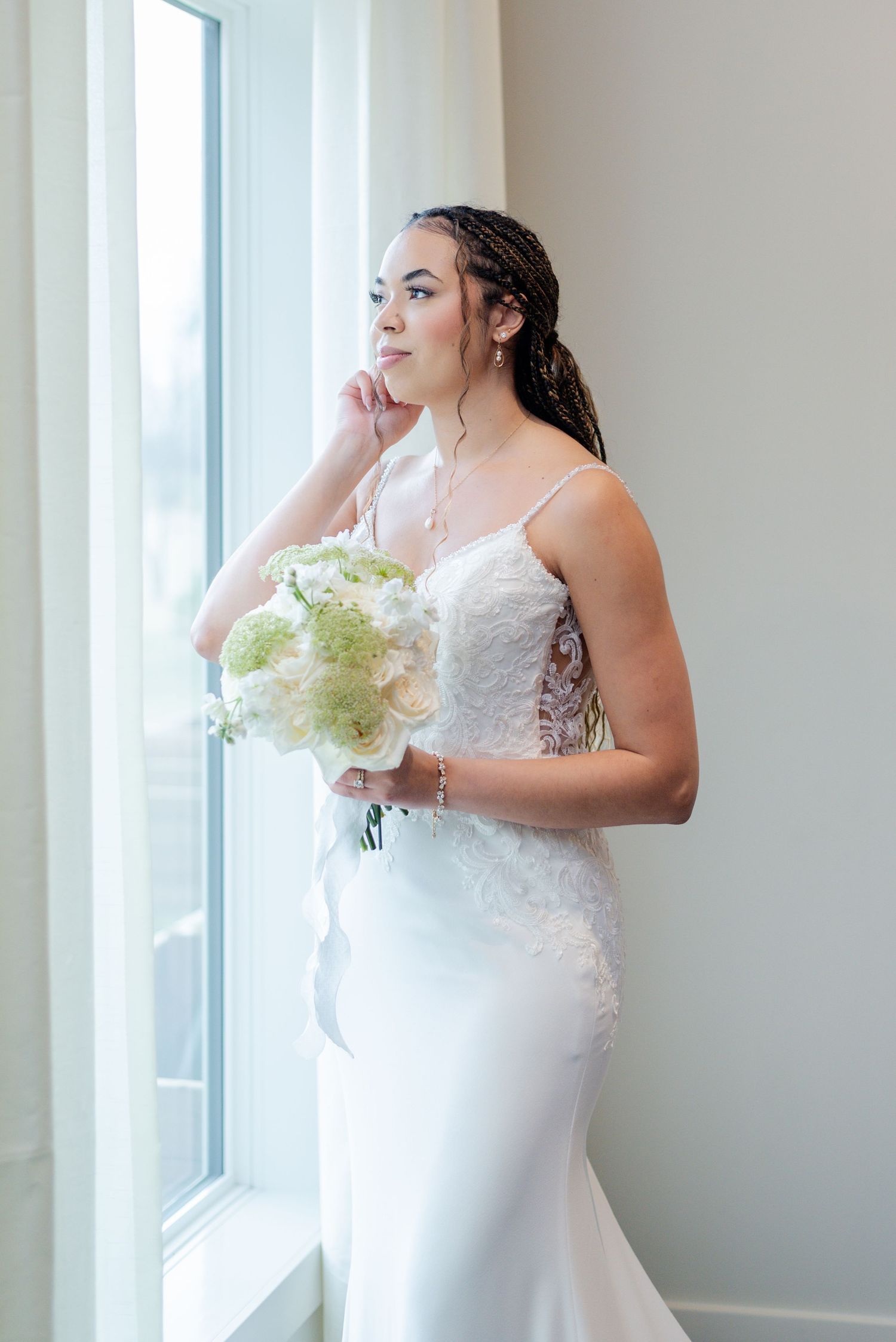 A bride posing in-front of a window