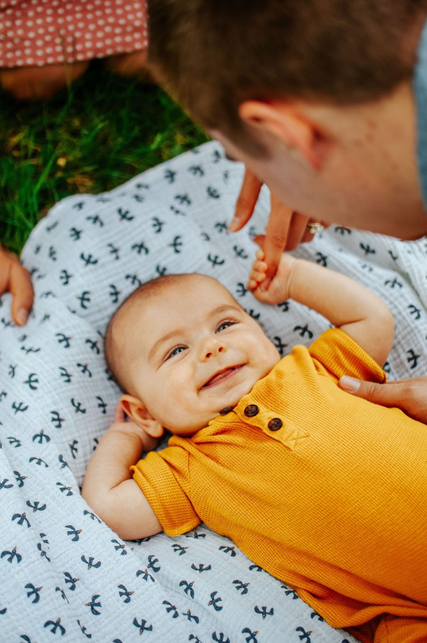 Baby plays on ground with parents
