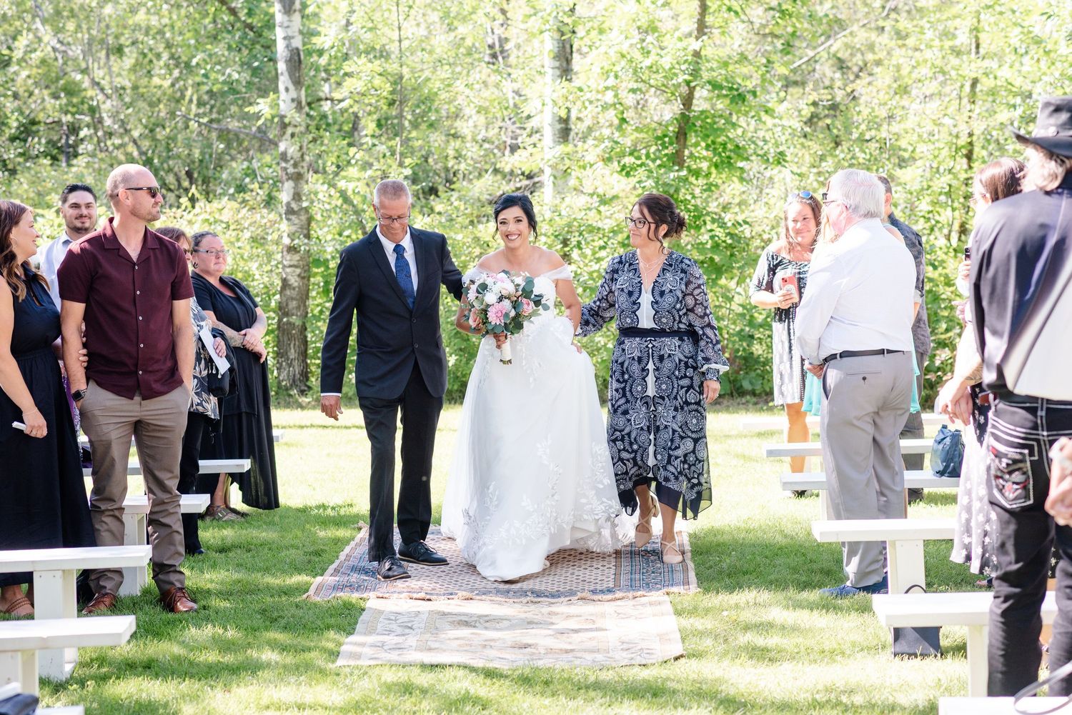 bride walks down isle with both parents