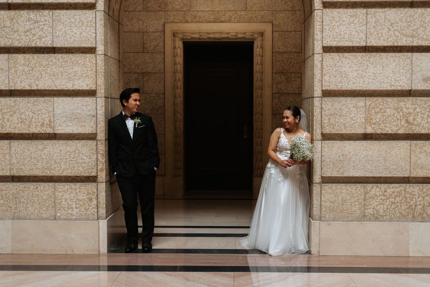 bride and groom look at eachother