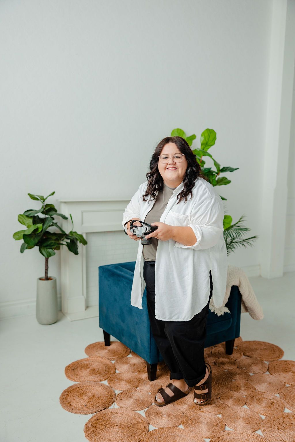 photographer holds camera smiling