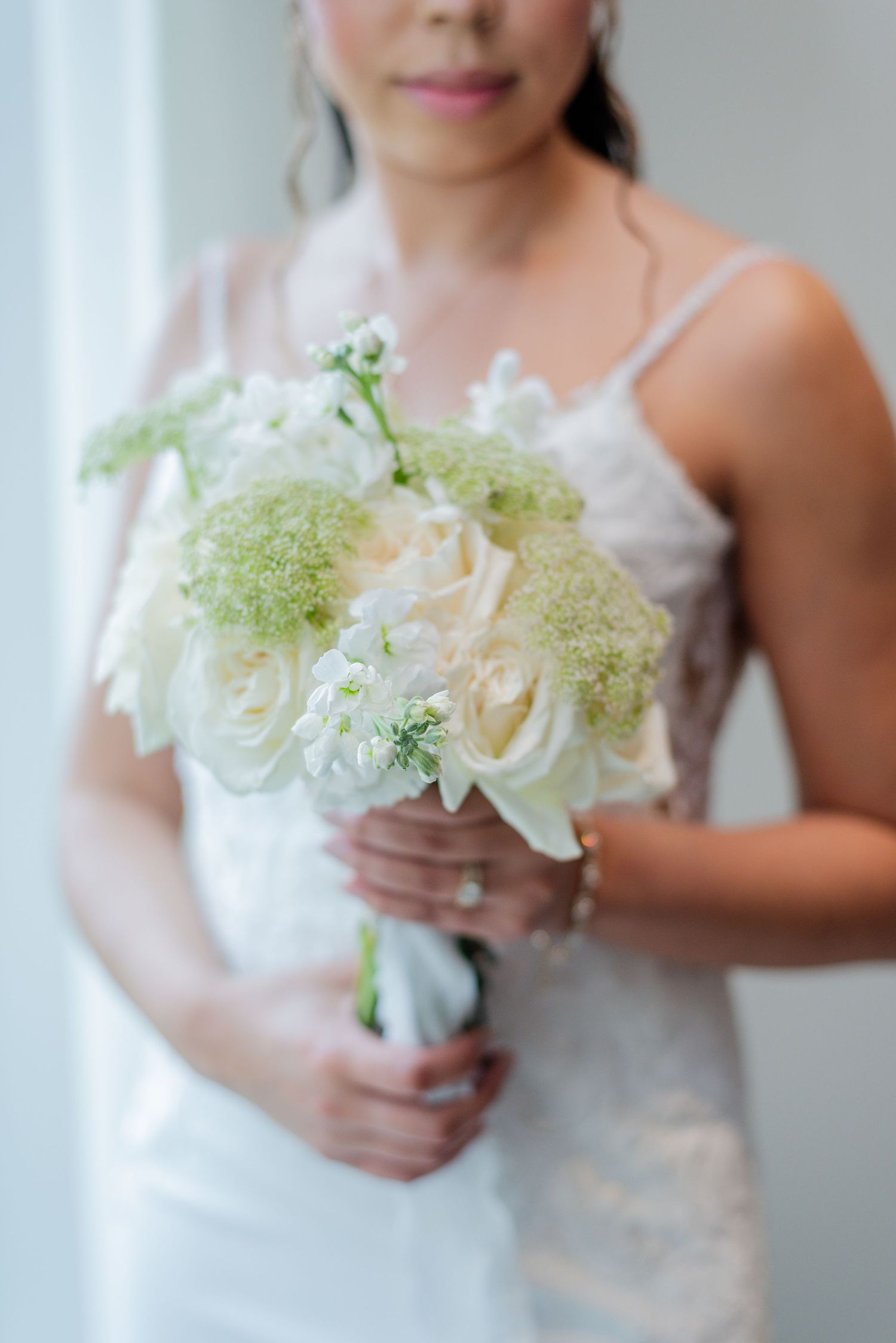 A bride posing in-front of a window