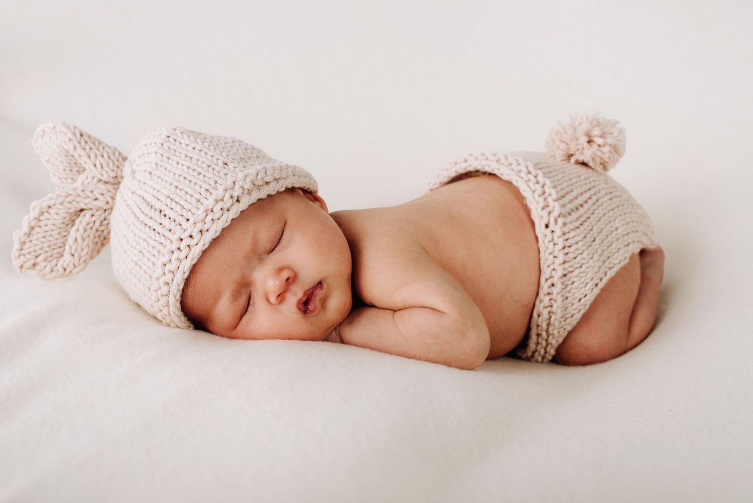 Baby lays on tummy with bunny outfit