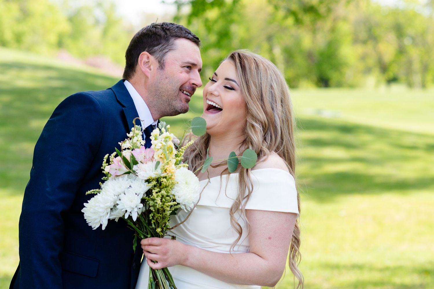 a bride laughs at her groom