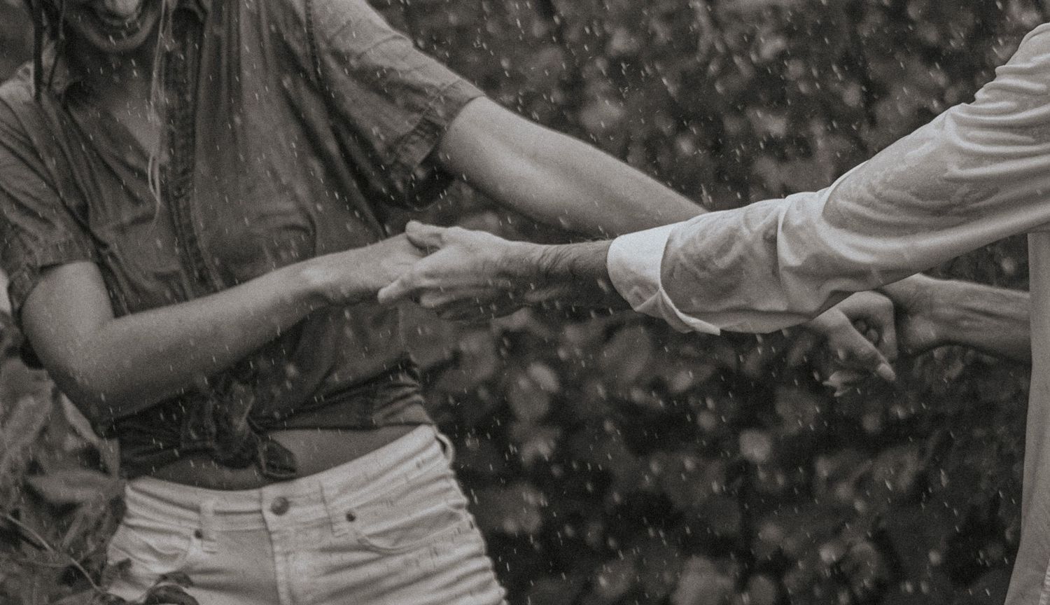 couple frolik in the rain