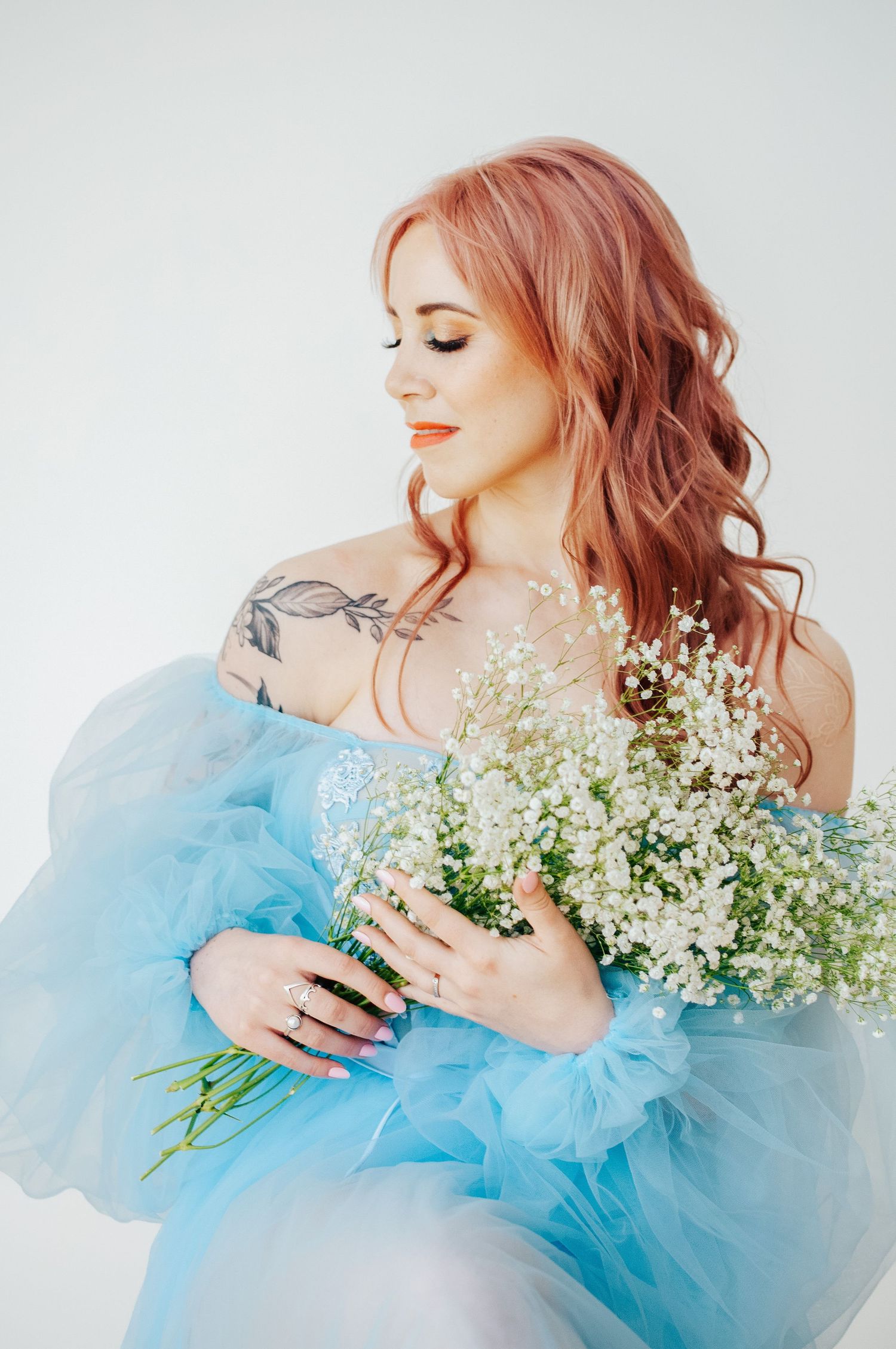 Woman holds flowers during photoshoot