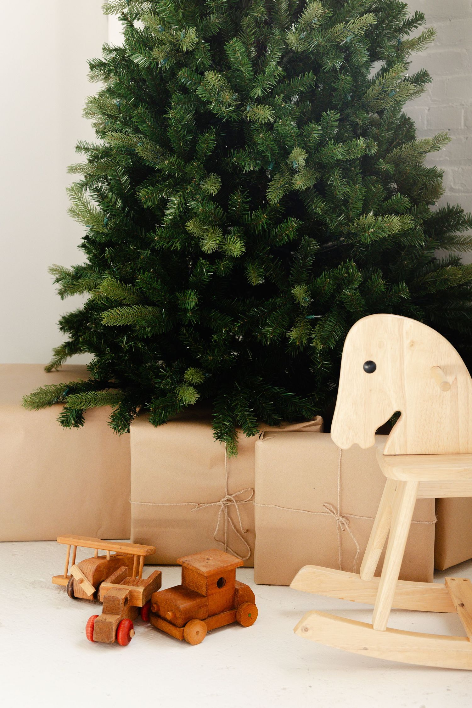 Minimalist xmas set up with brown presents, bells hanging from wreath